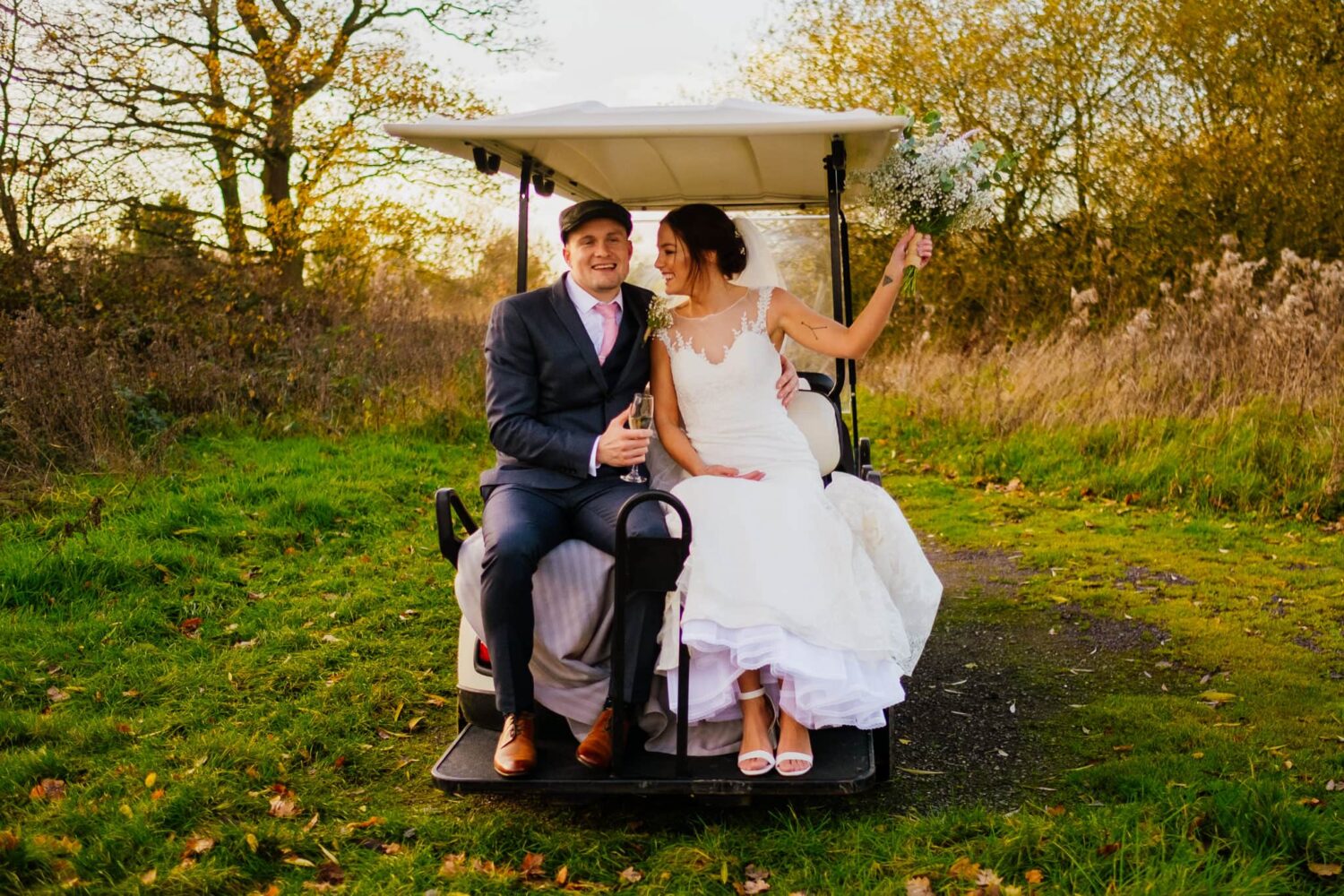 just married couple celebrate on a golf buggy at styal lodge