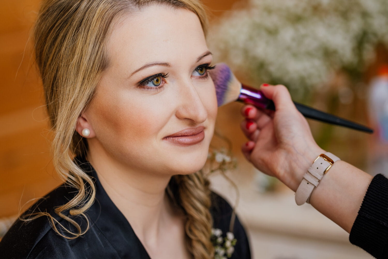 bride having her makeup done in window light at styal lodge