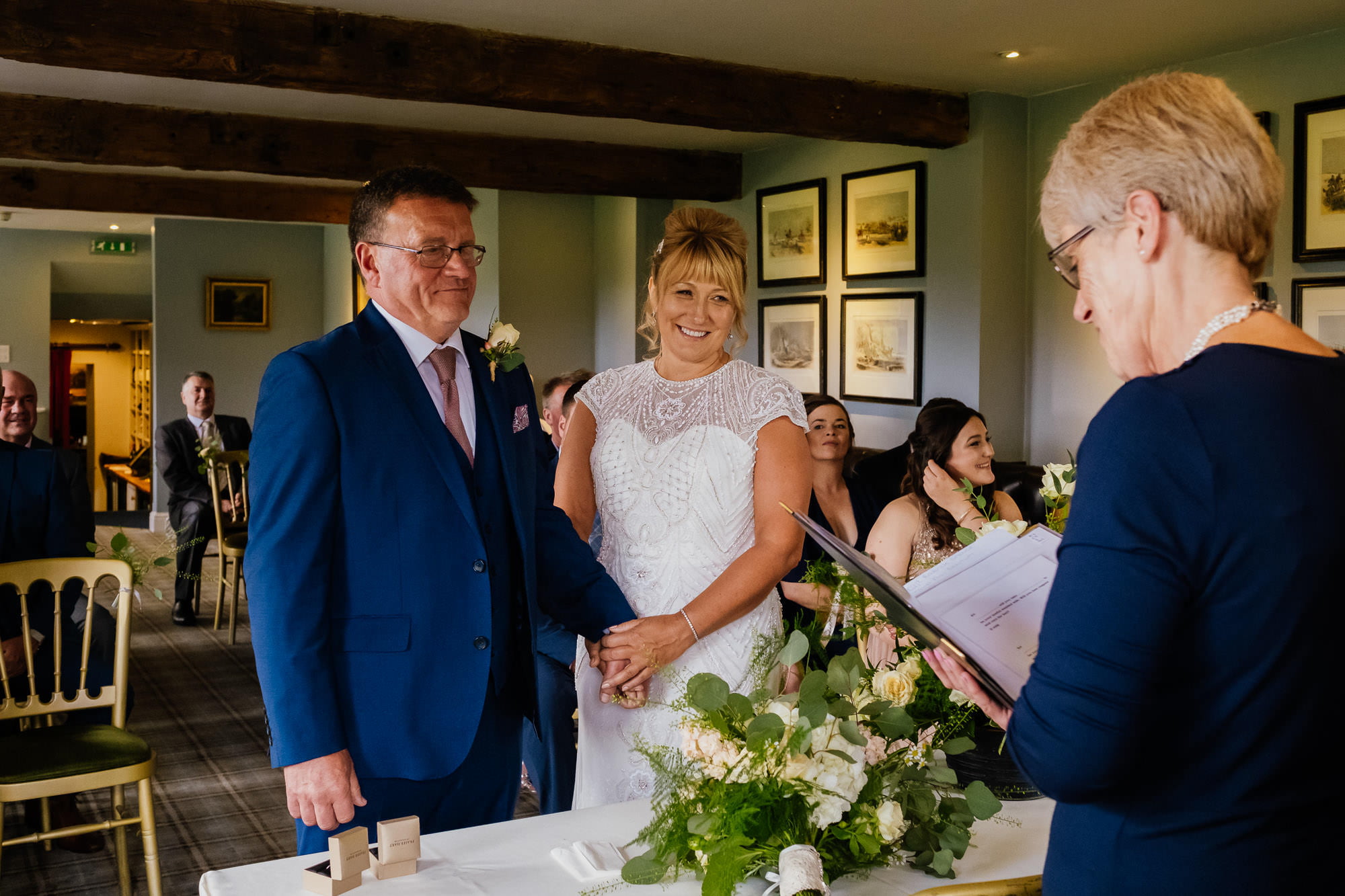 Bride and groom holding hands in ceremony