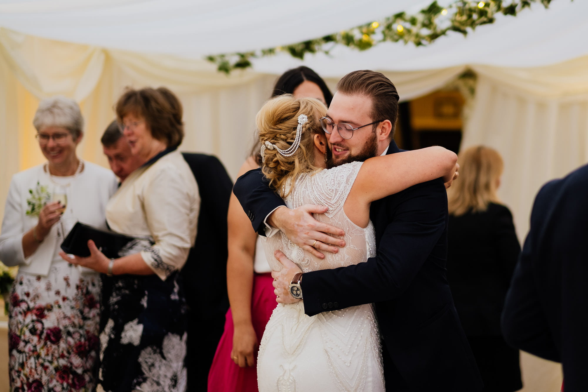 Bride hugging wedding guest