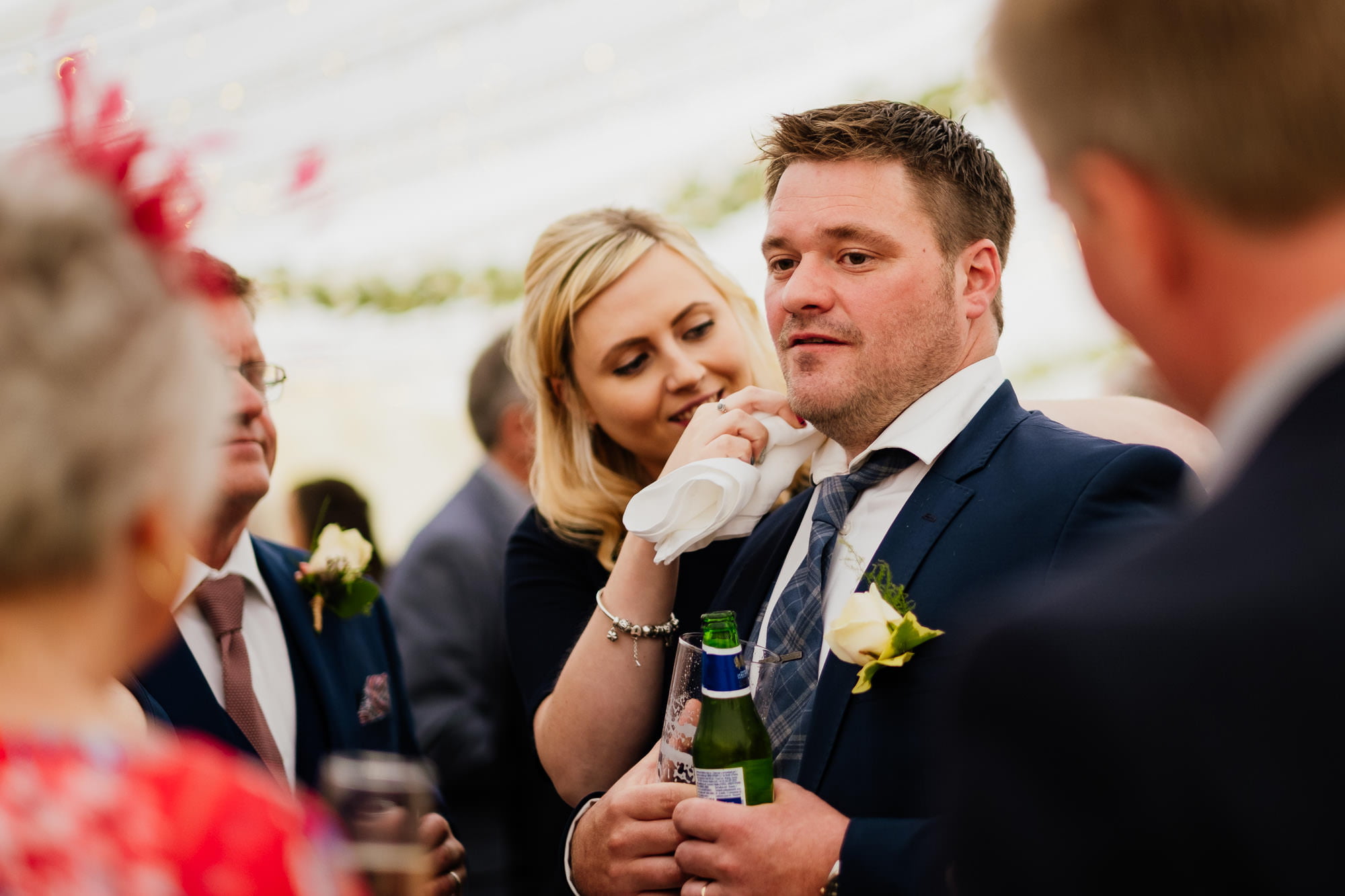 Wedding guest wiping man’s collar