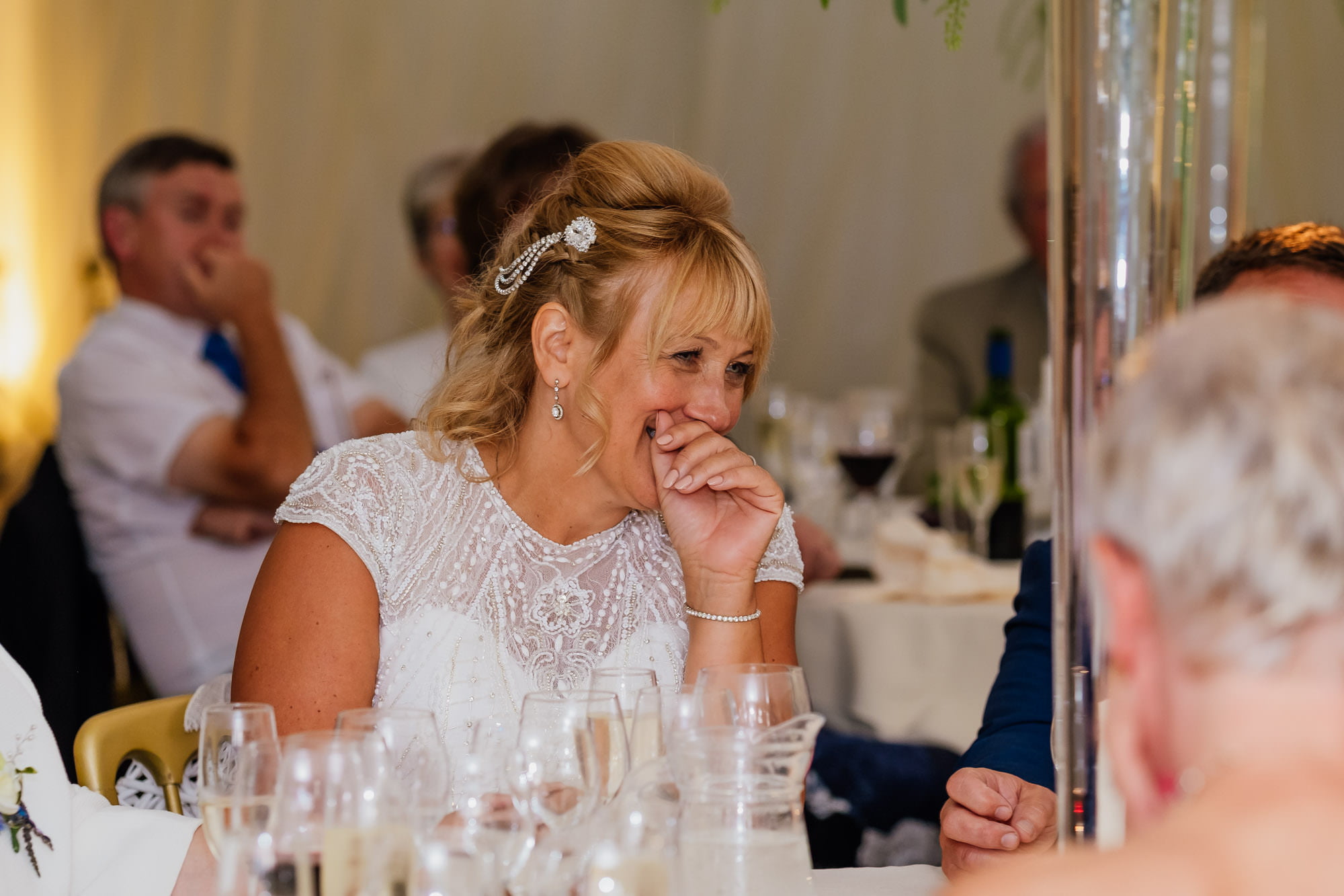 Bride laughing during wedding speech
