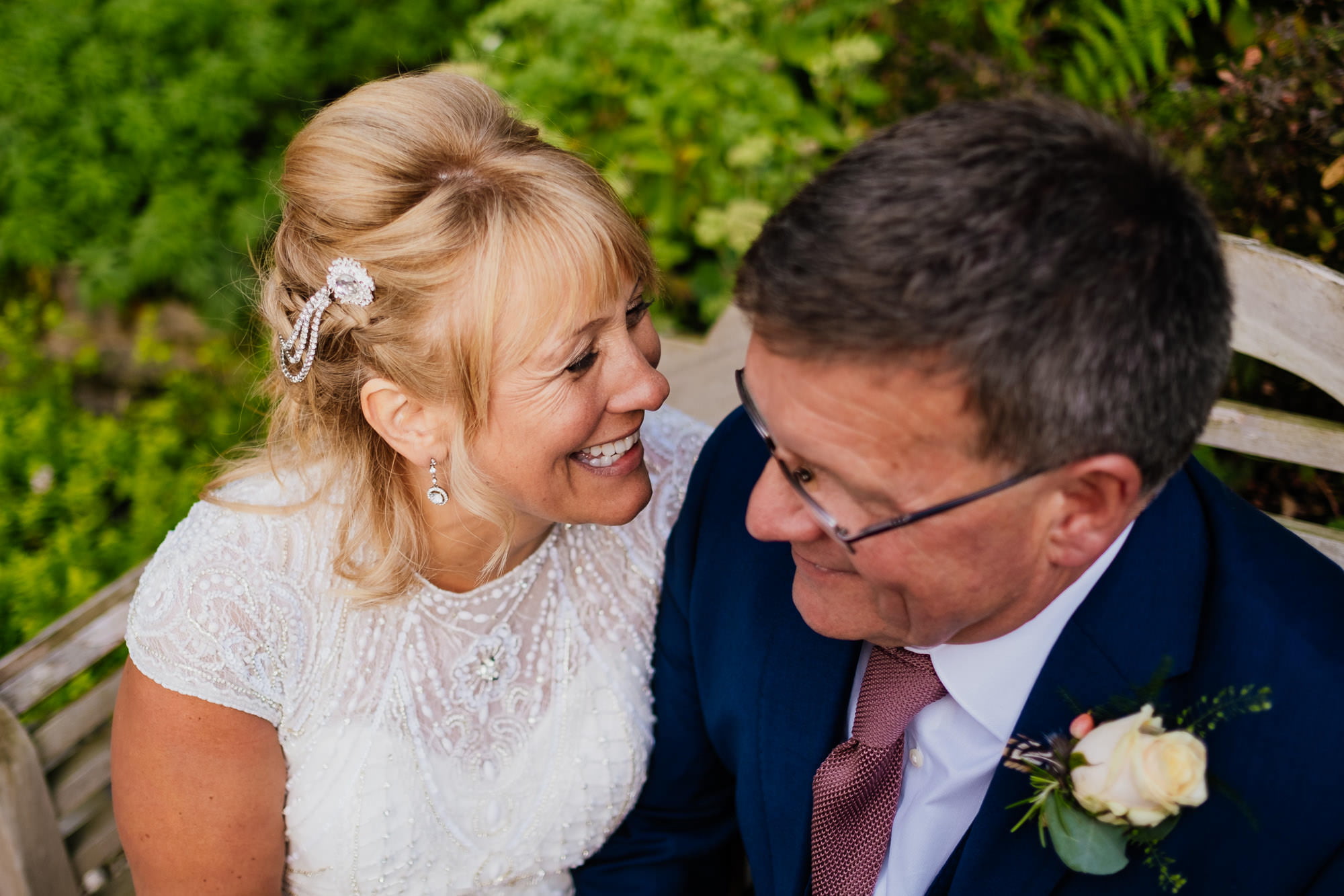 Couple close up portrait sat on bench