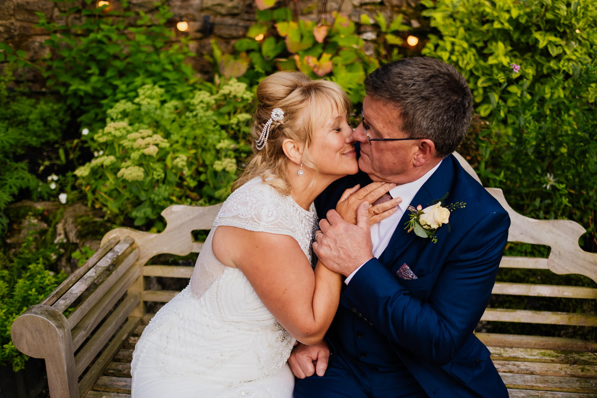 Couple portraits on a bench at the inn at whitewell