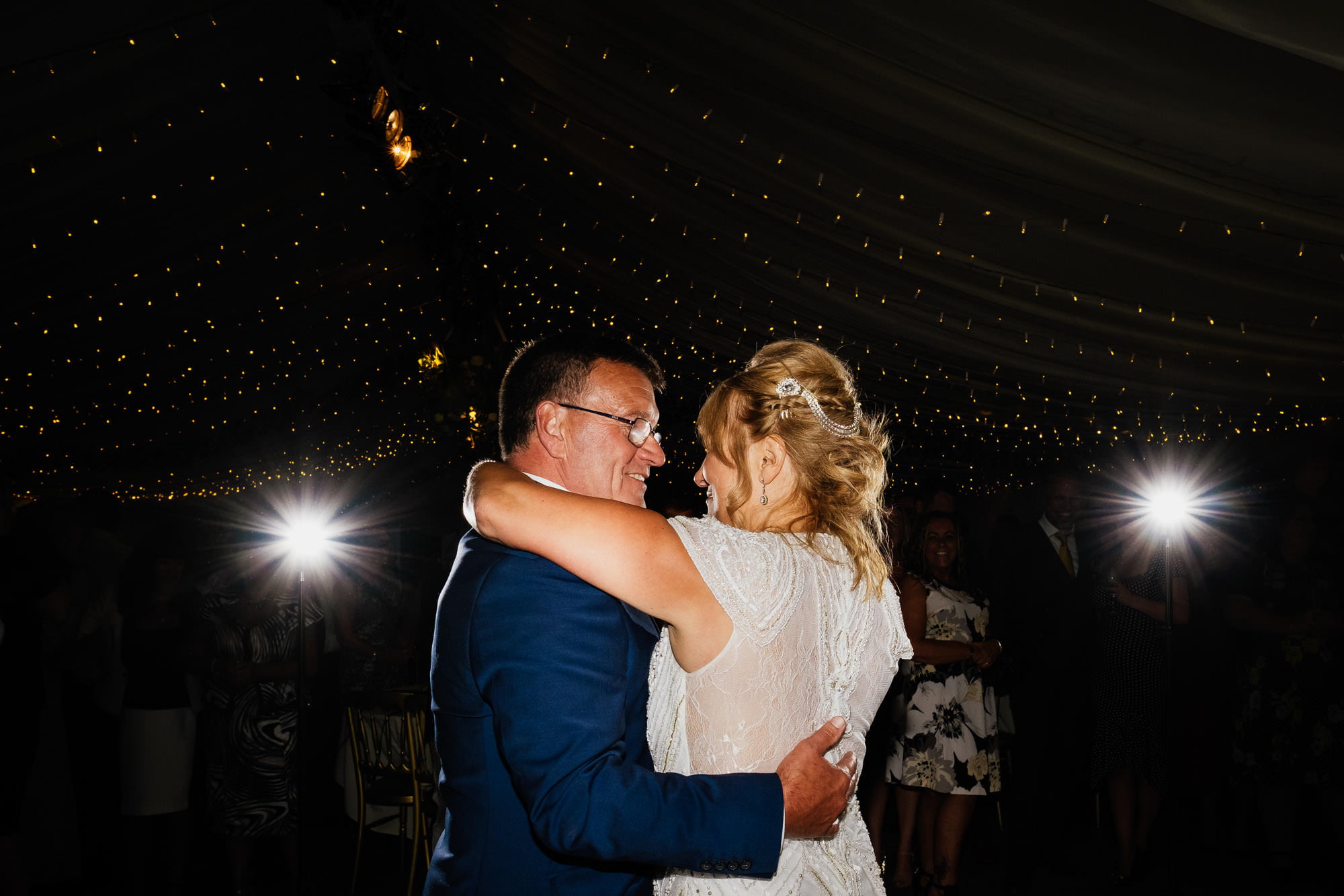 Couple first dance hug in marquee