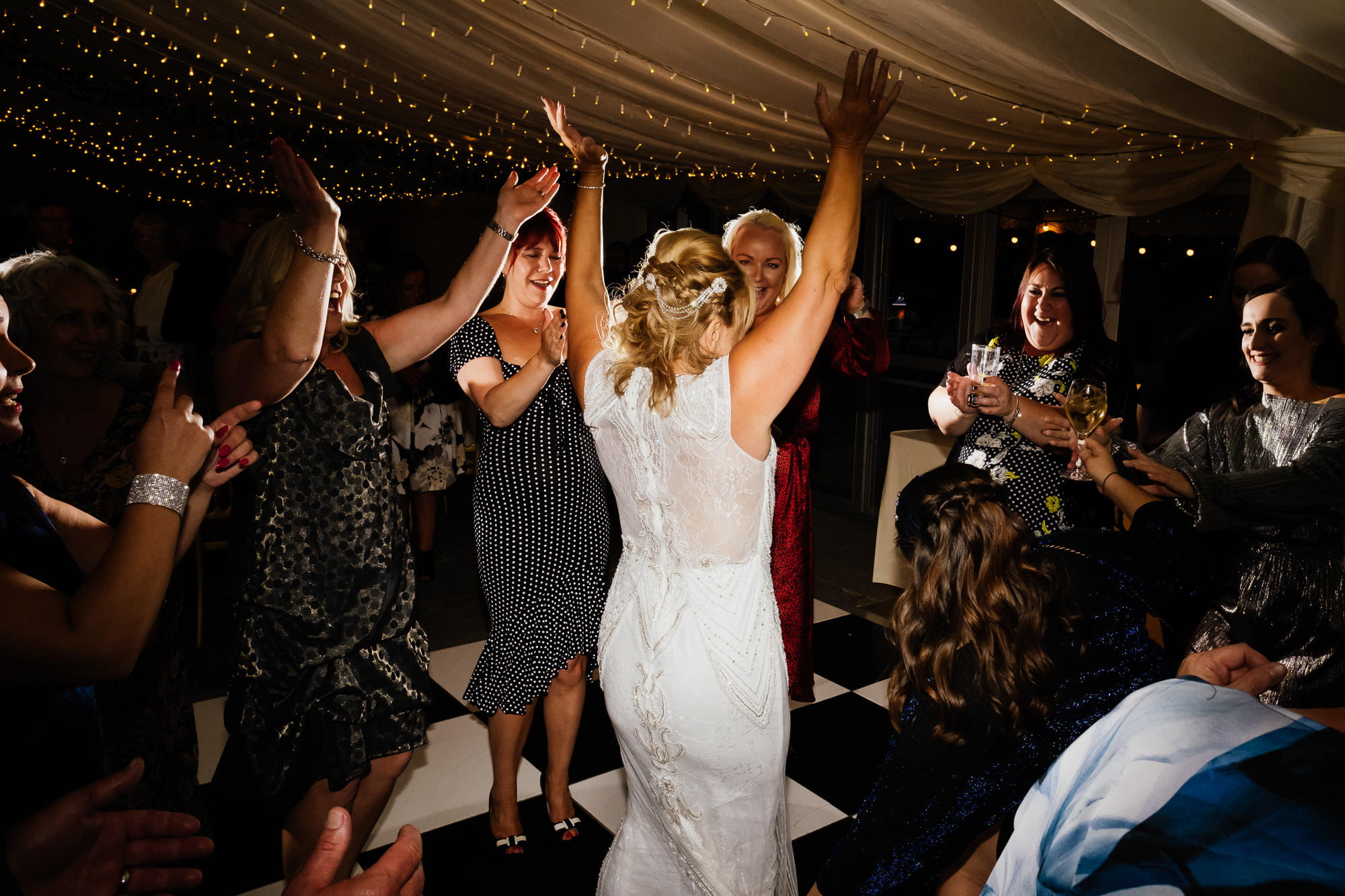 Bride dancing surrounded by wedding guests