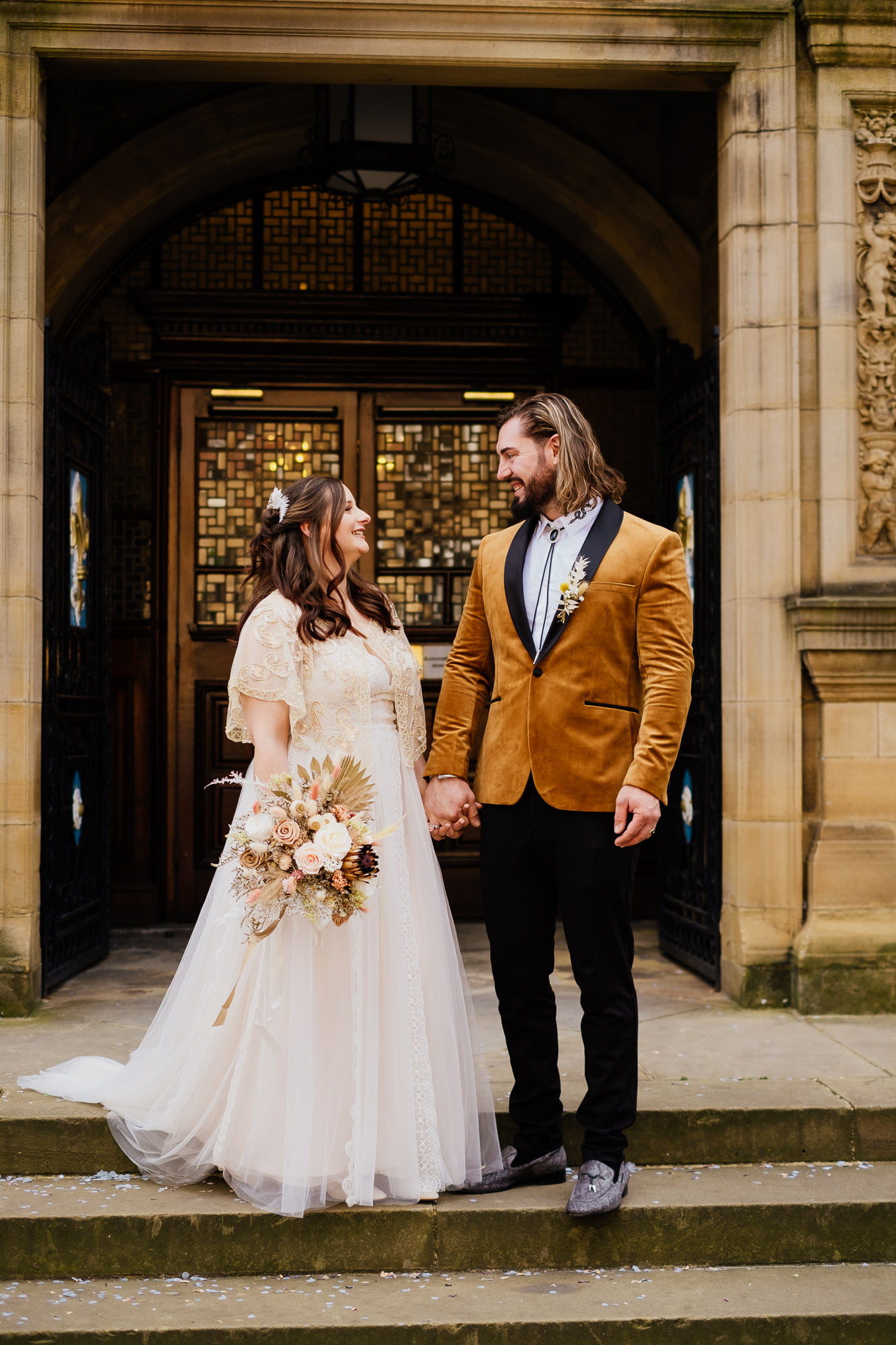 bride and groom on steps outside wakefield town hall