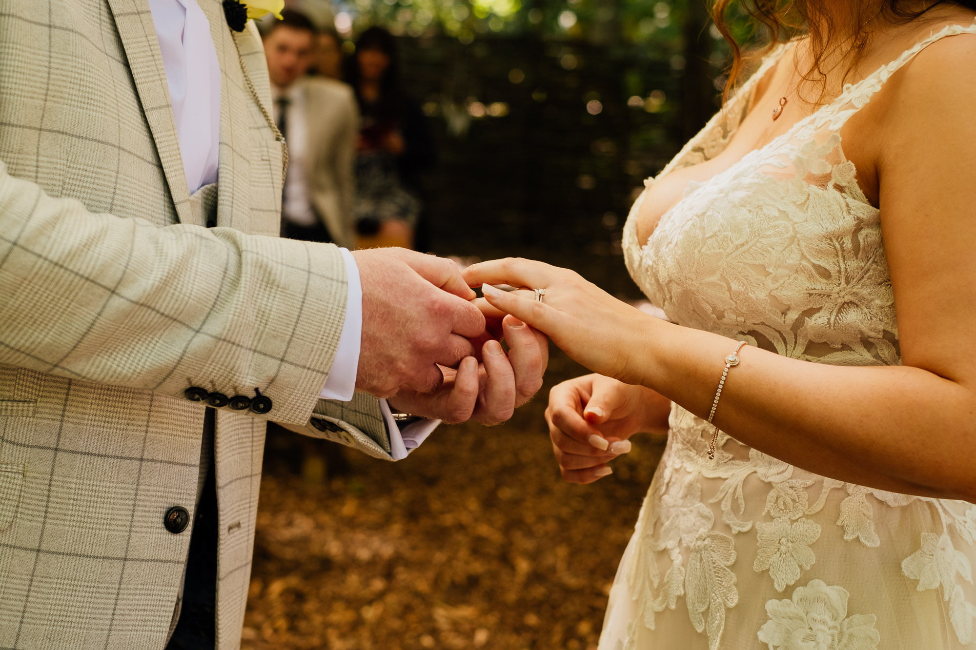 Grom placing ring on brides finger during ceremony