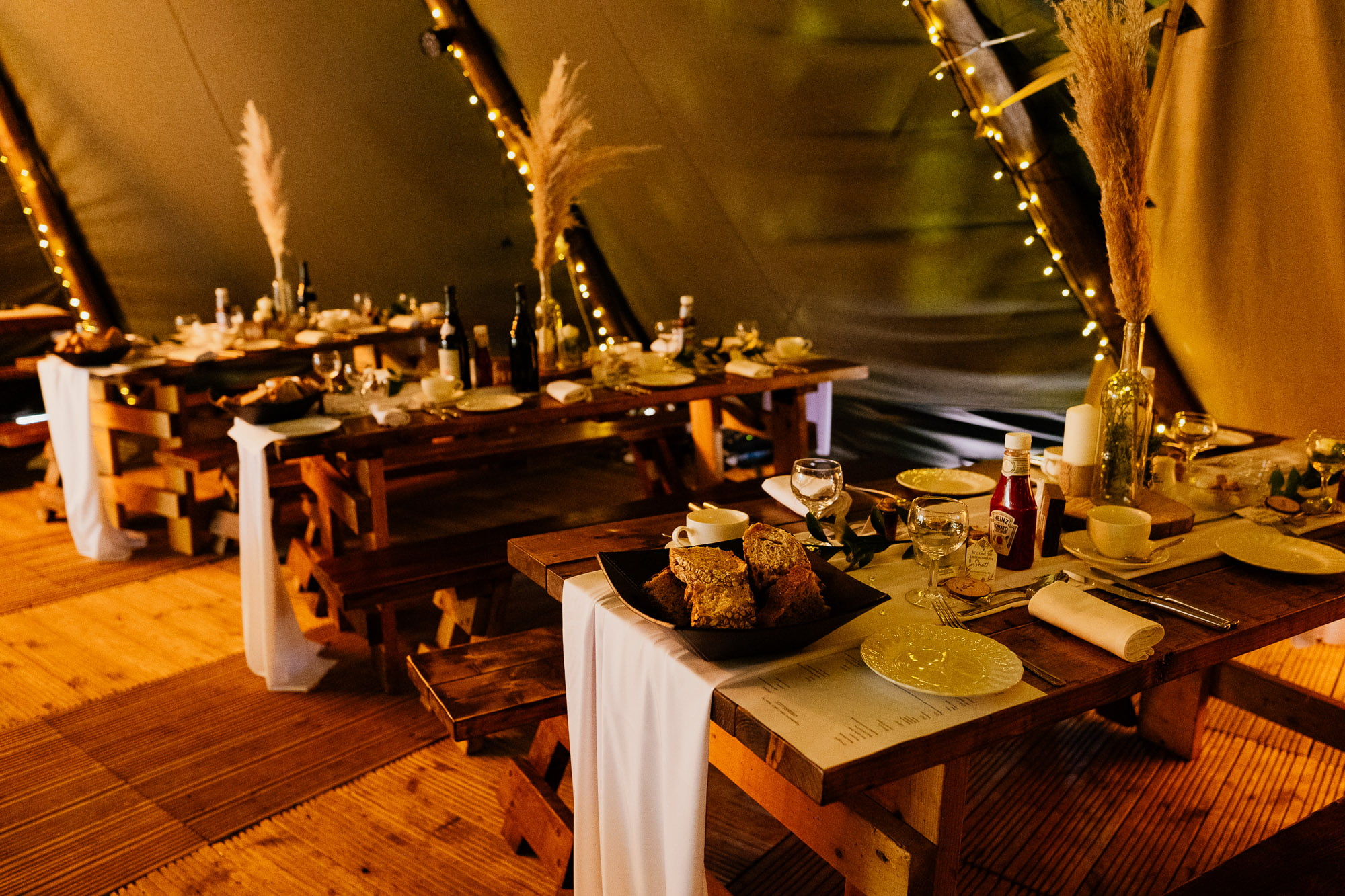 picnic benches in wedding tipi