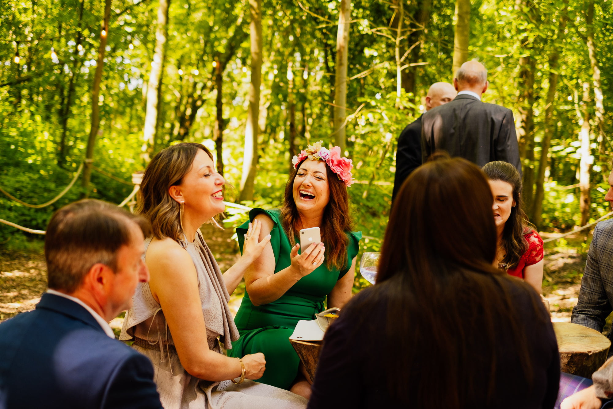 Wedding guests laughing at outdoor wedding