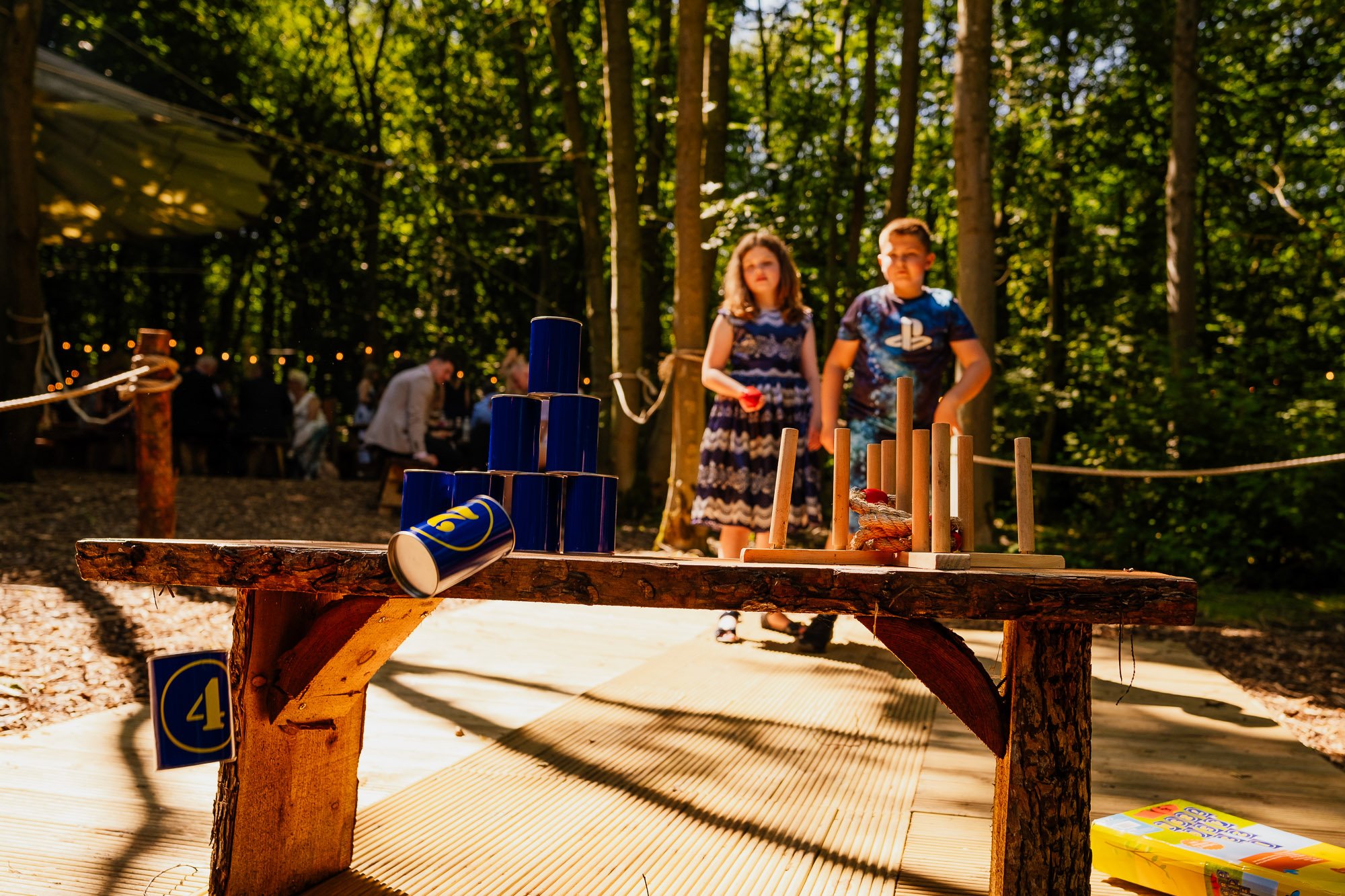 Children knocking down tin can tower