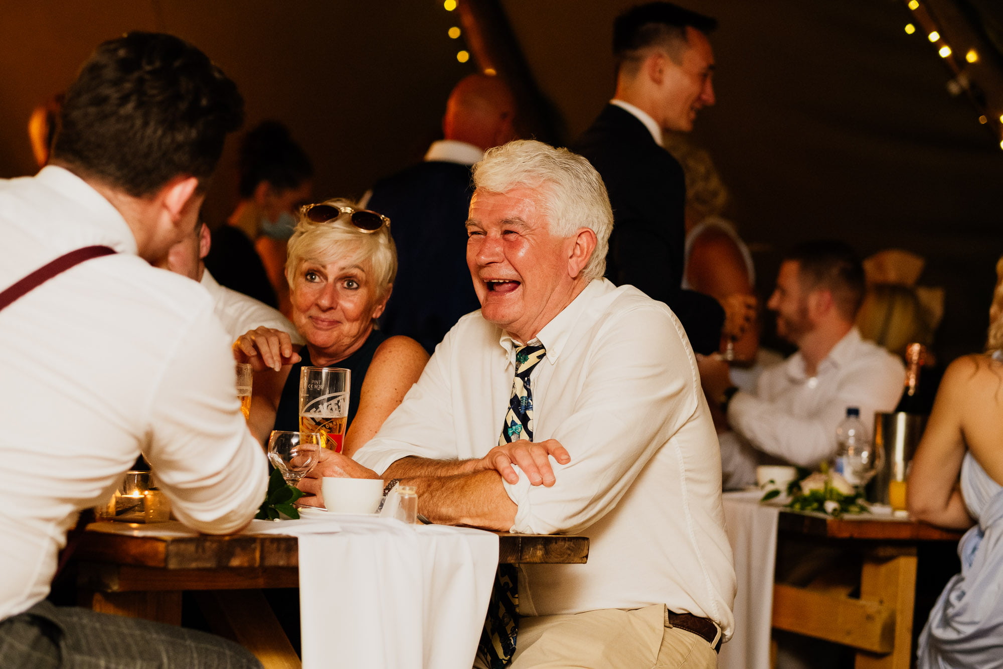 Wedding guest sat smiling during meal