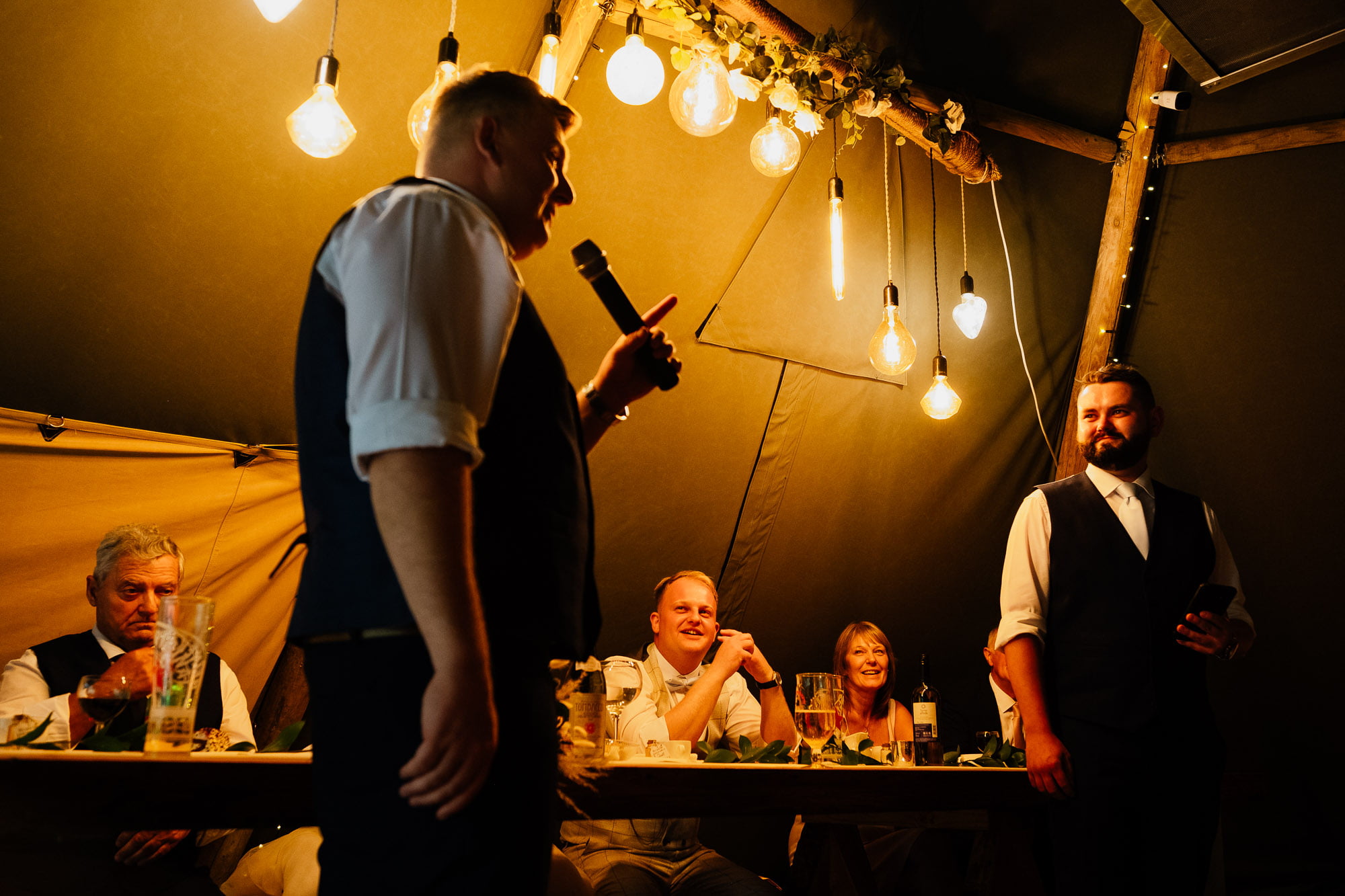 Groom reacting to wedding speech from best men