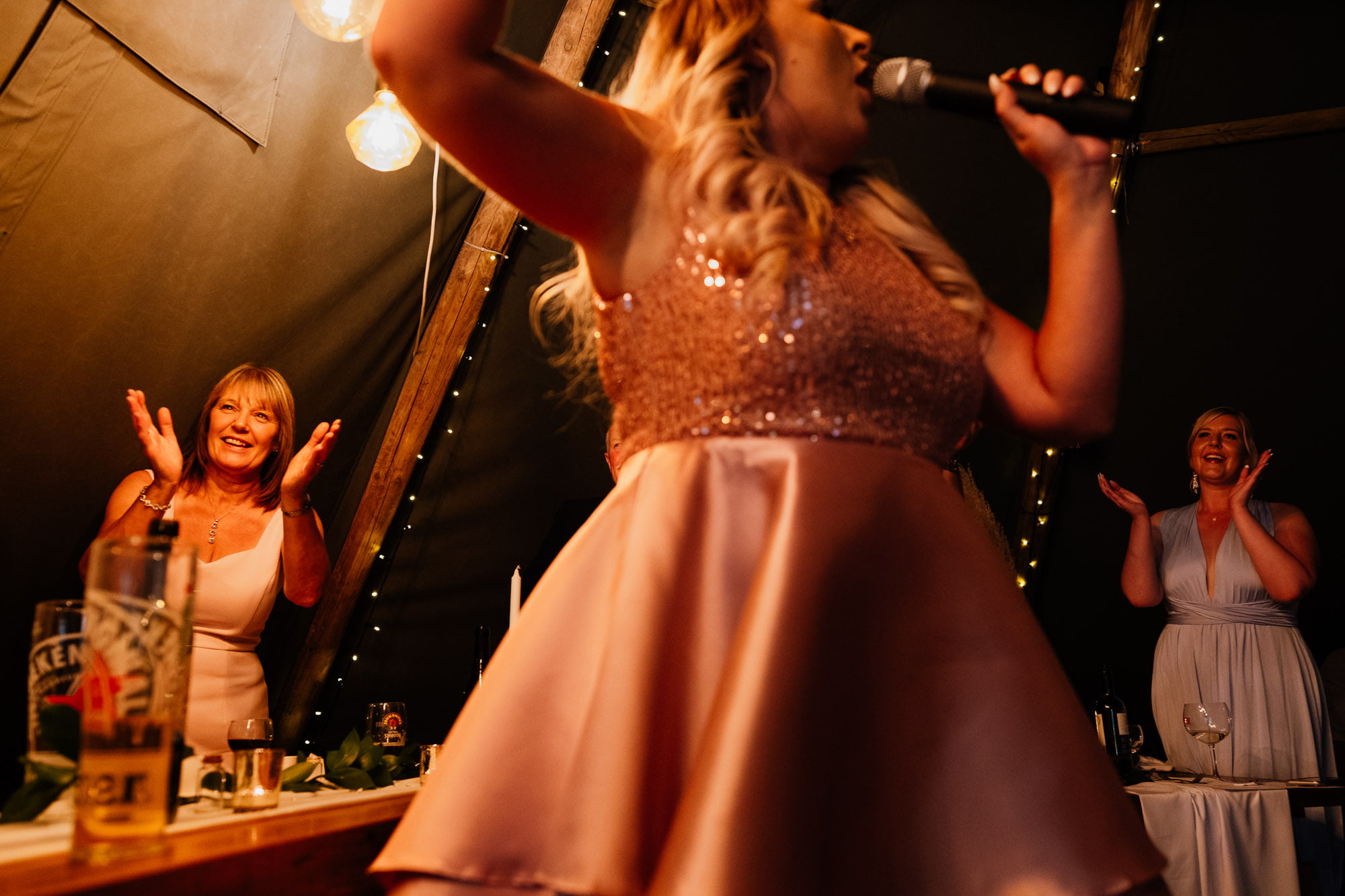 Wedding guests clapping with speaker in the foreground