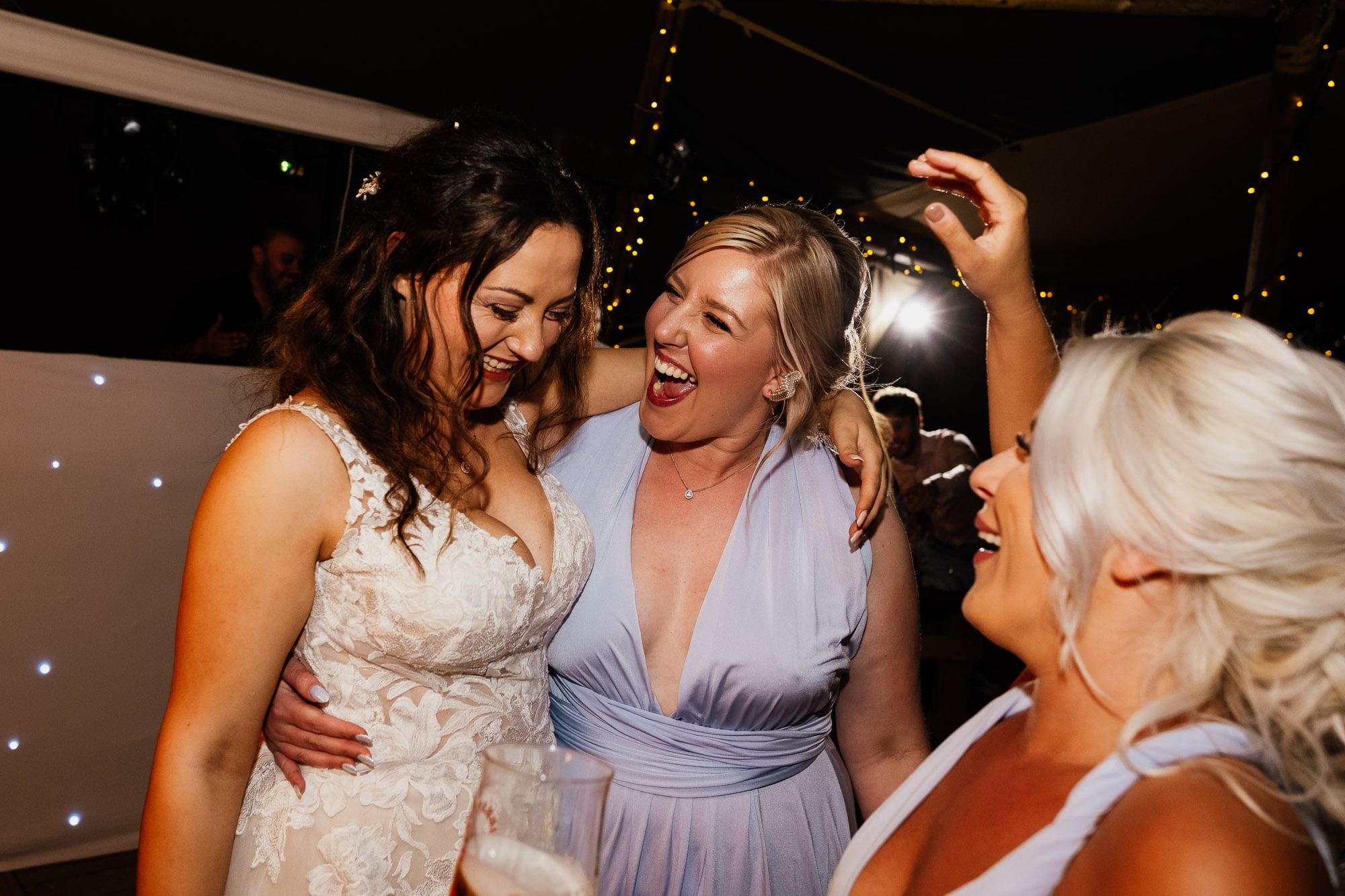 bride and friends hugging after first dance