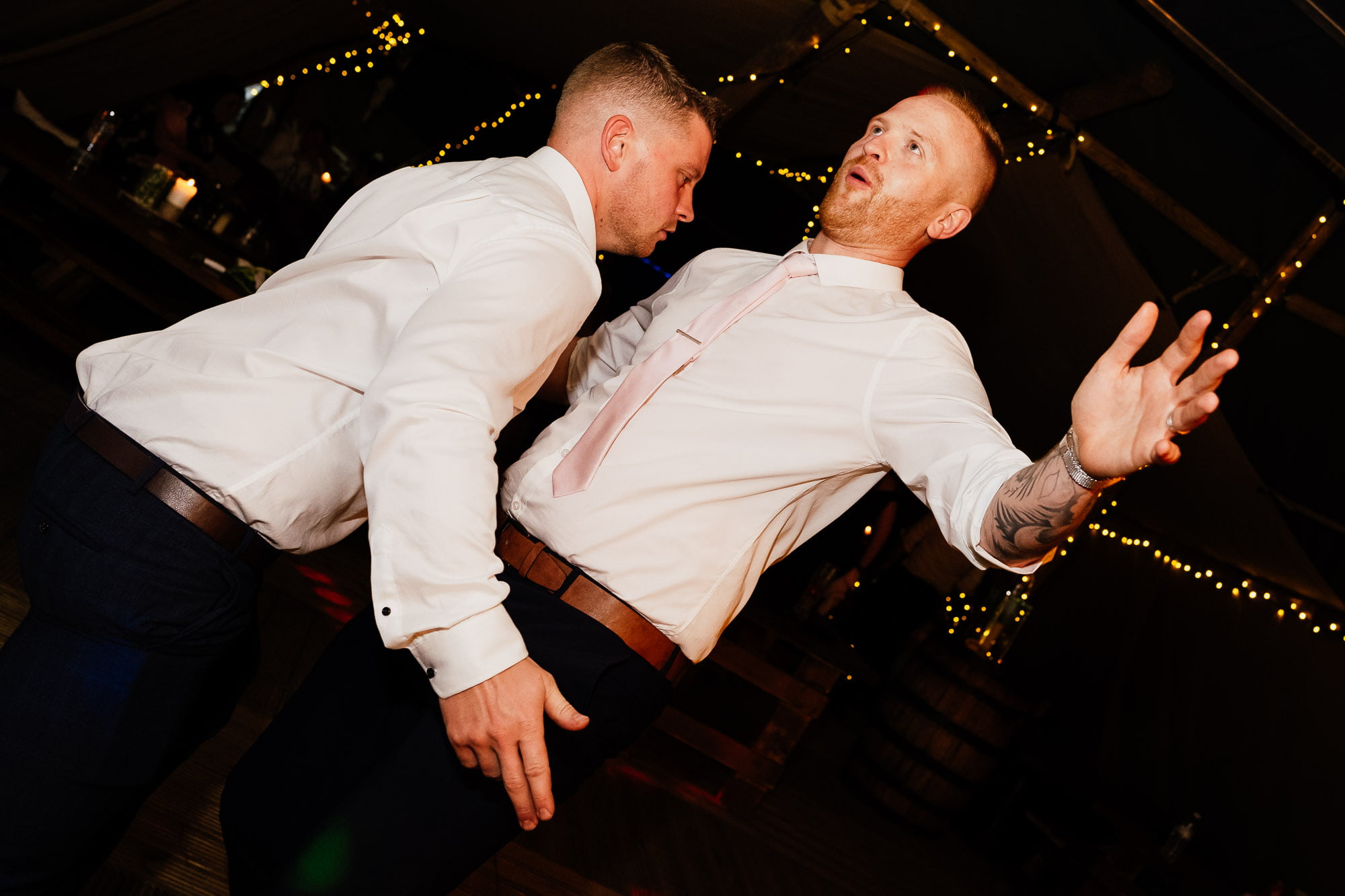 two guests in white shirts dancing with each other