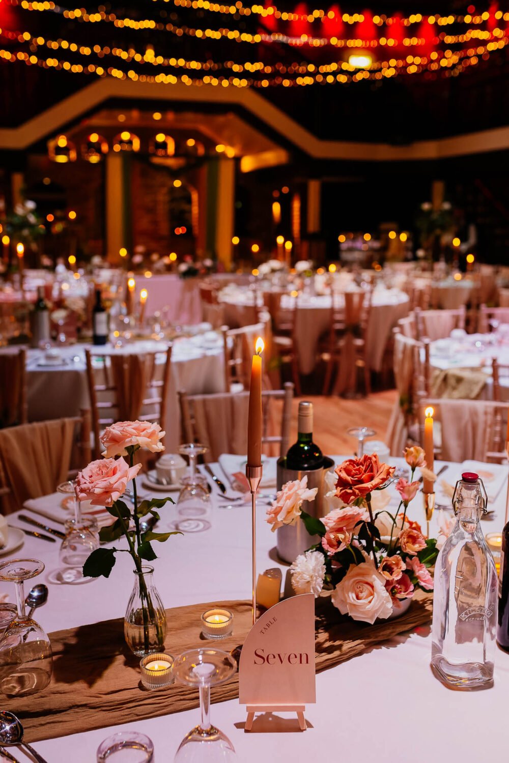 The Engine Shed wedding breakfast decor with pink flowers and candles