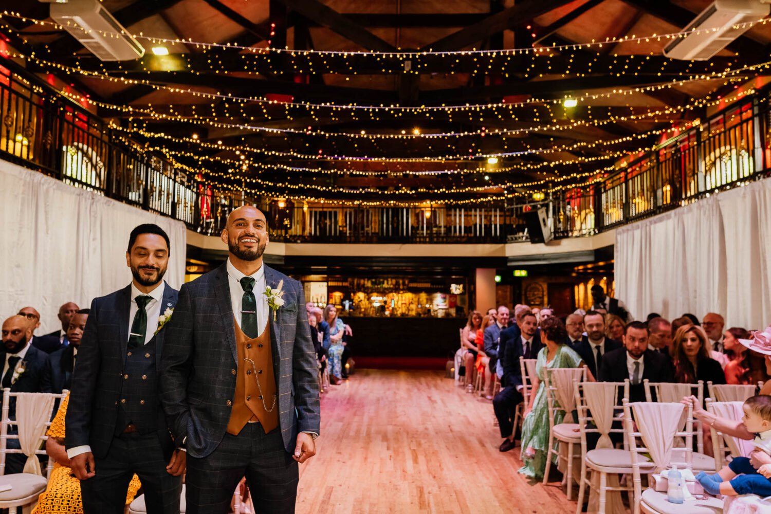 Groom waiting for bride at The Engine Shed ceremony with fairy light canopy