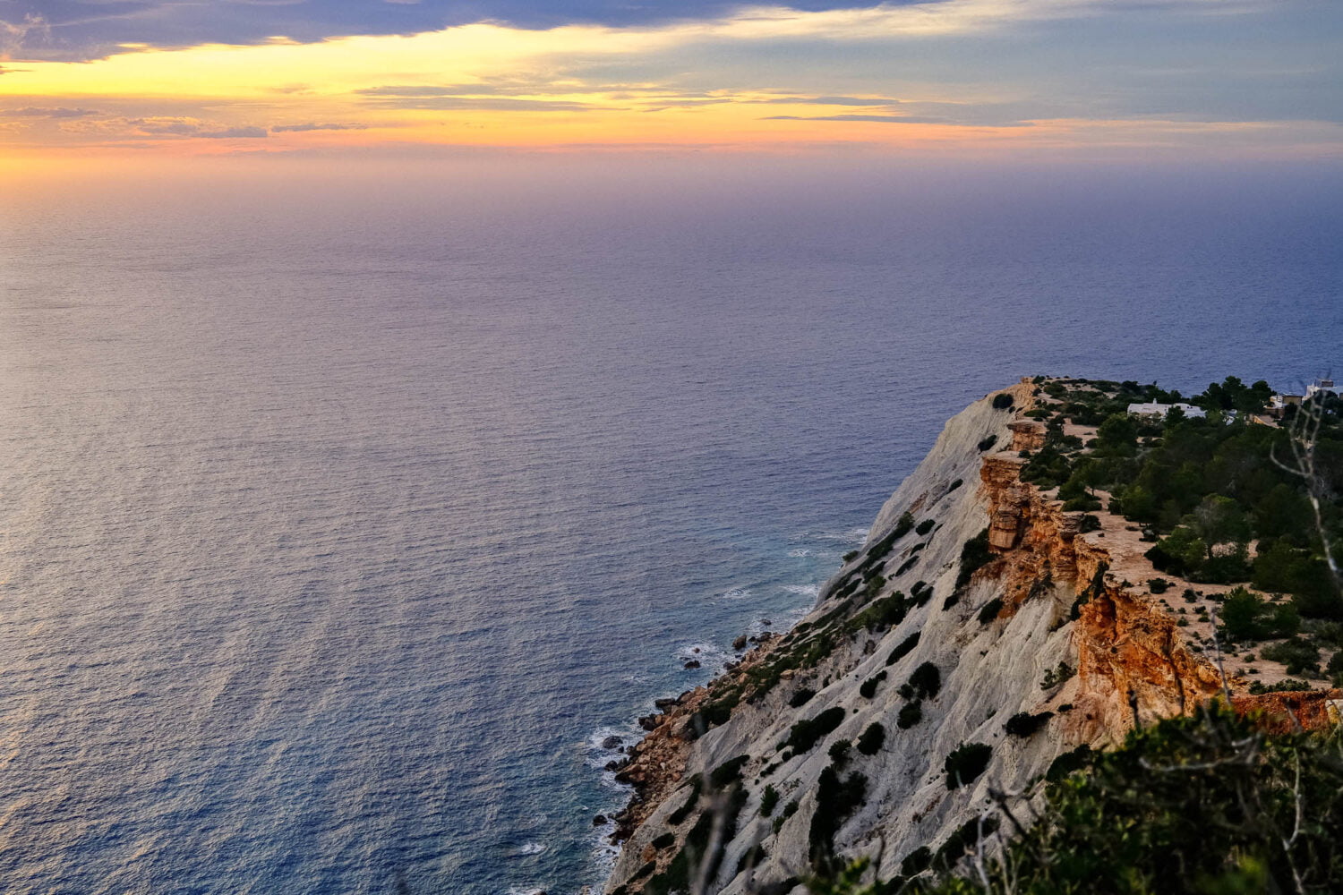 Cliff over the sea at sunset in Ibiza