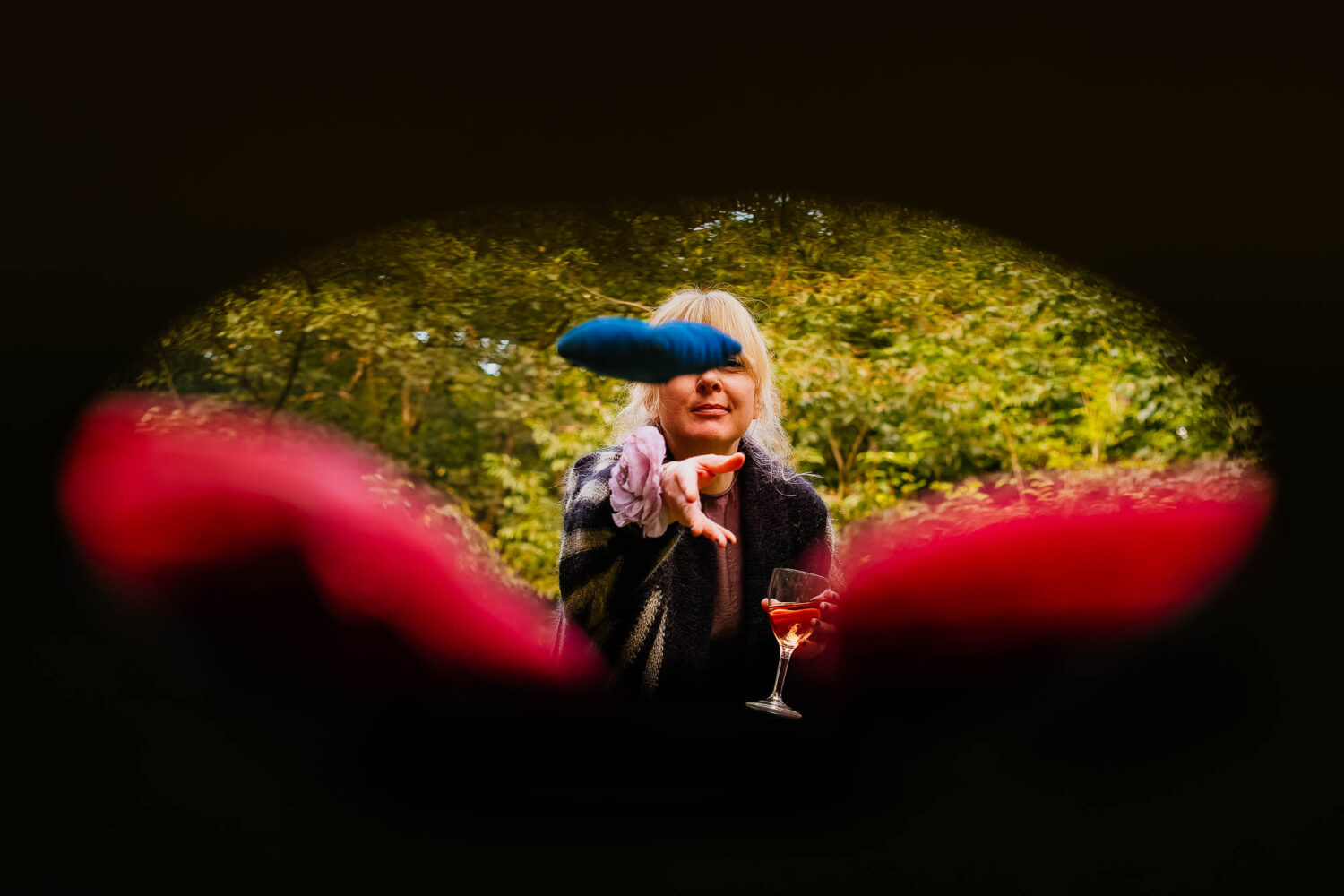 Wedding guest playing corn hole from the perspective of the hole