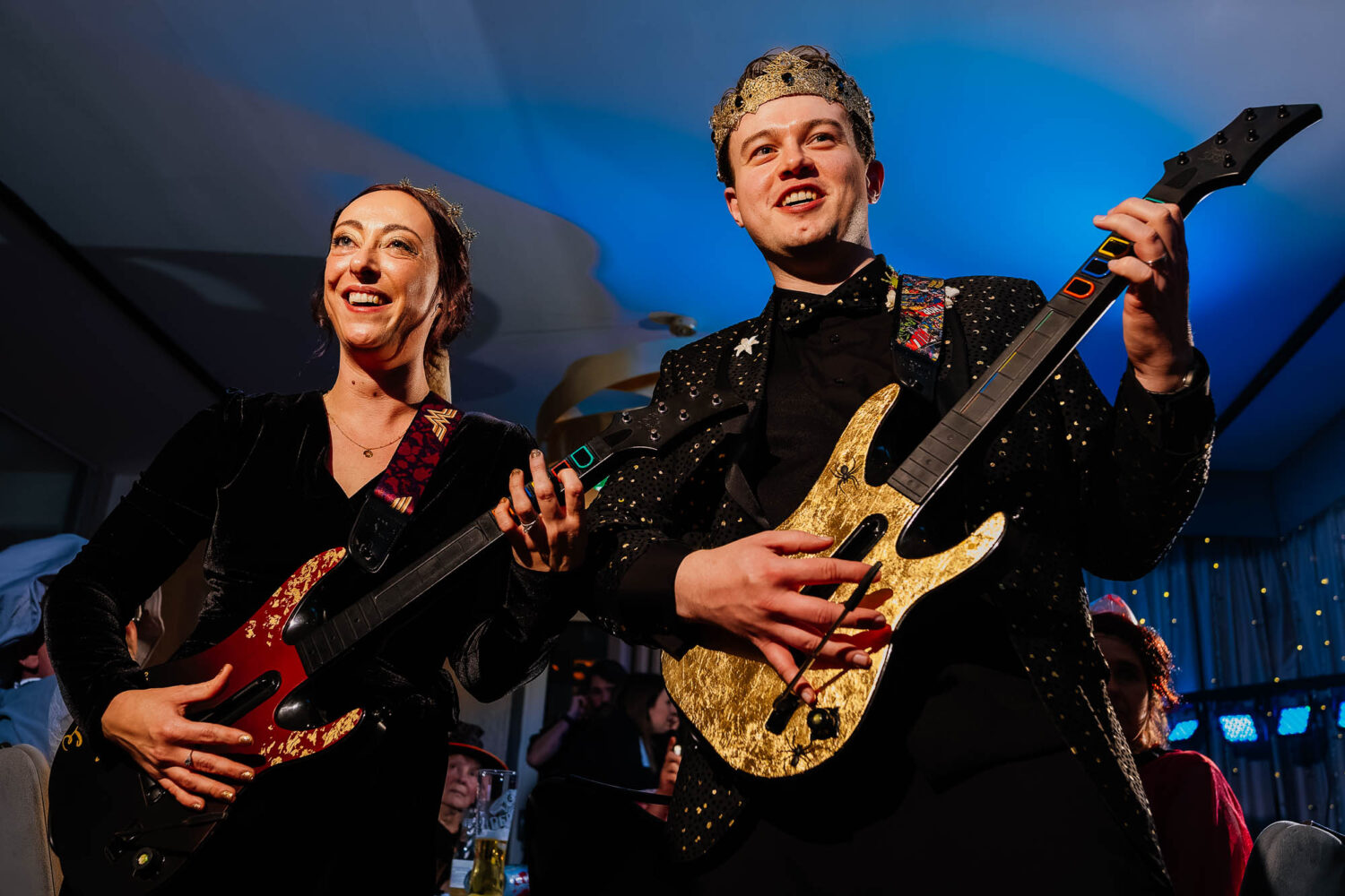 Bride and groom playing guitar hero at wedding reception