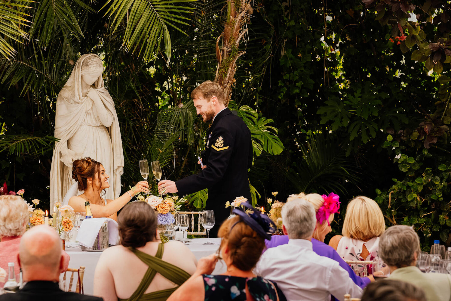 Bride and groom cheers during wedding speeches