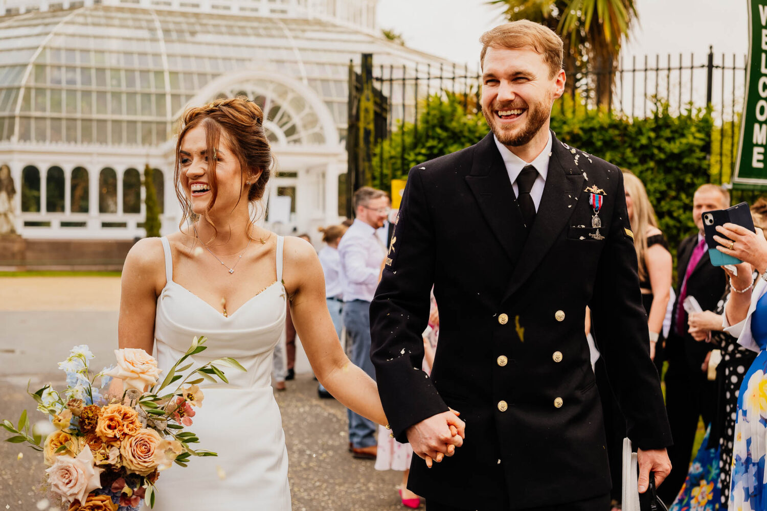 Bride and groom smiling during confetti photo at the Palm House