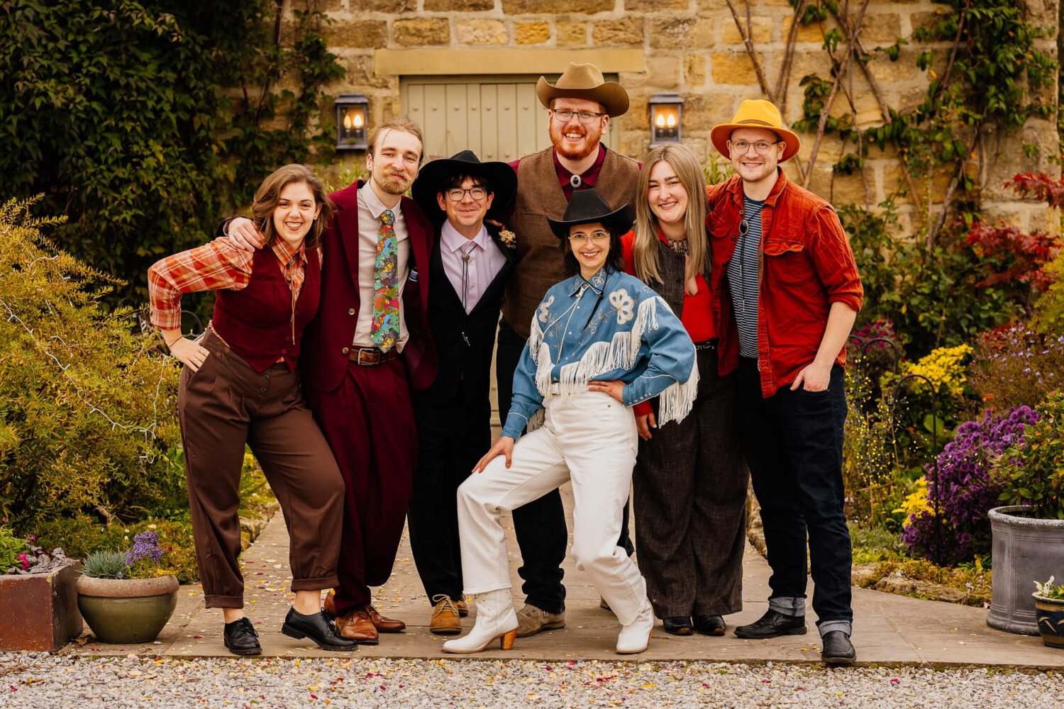 Fun wedding group photo with cowboy theme