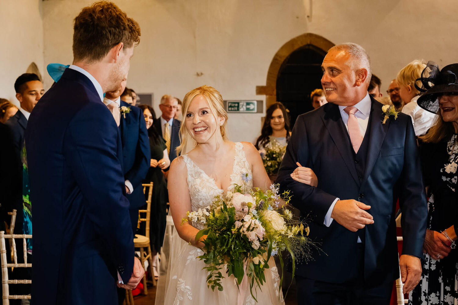 Bride walking down the aisle at Bolton Castle with her dad