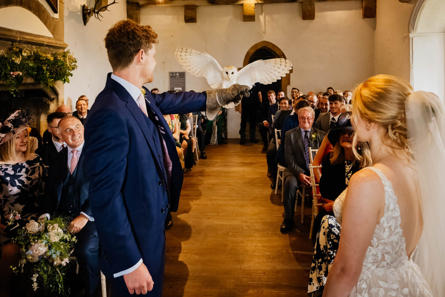 Owl ring-bearer mid-flight during Bolton Castle wedding ceremony