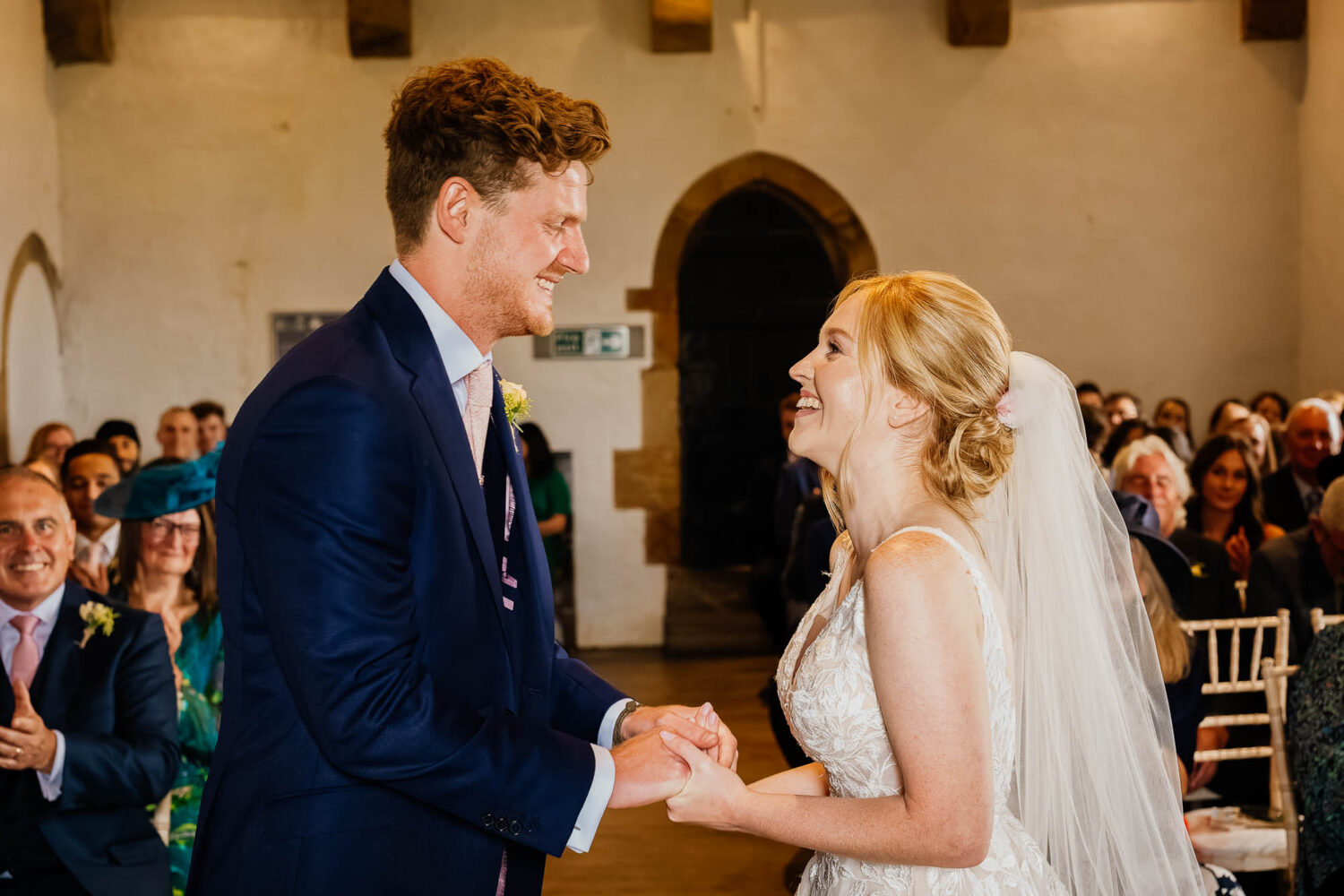Bride and groom holding hands during Bolton Castle wedding