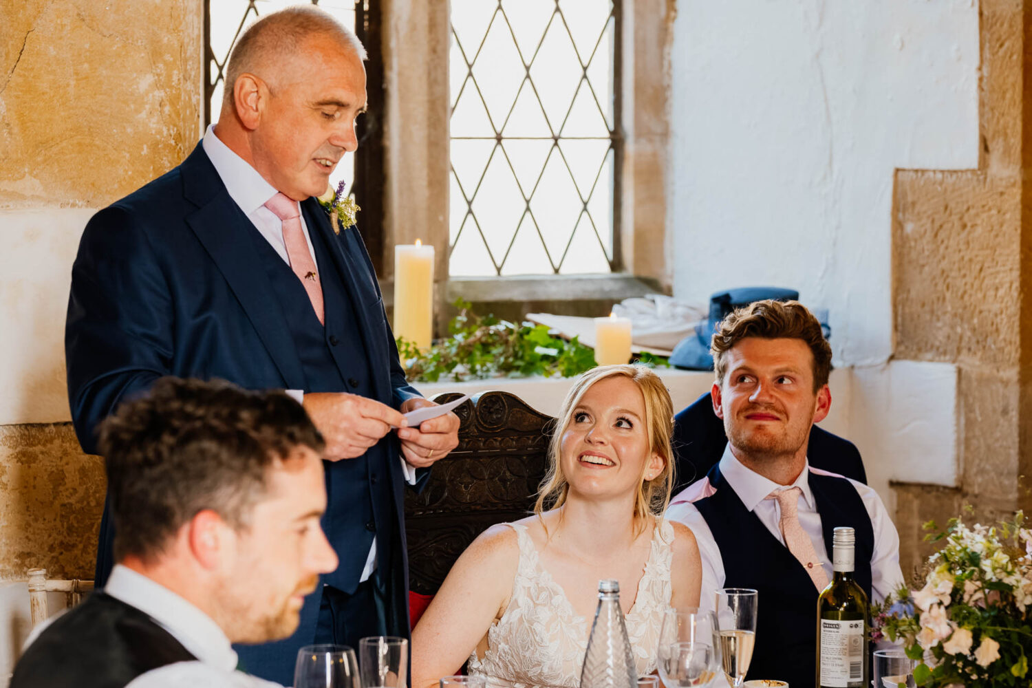 Bride watching father give a speech at their wedding