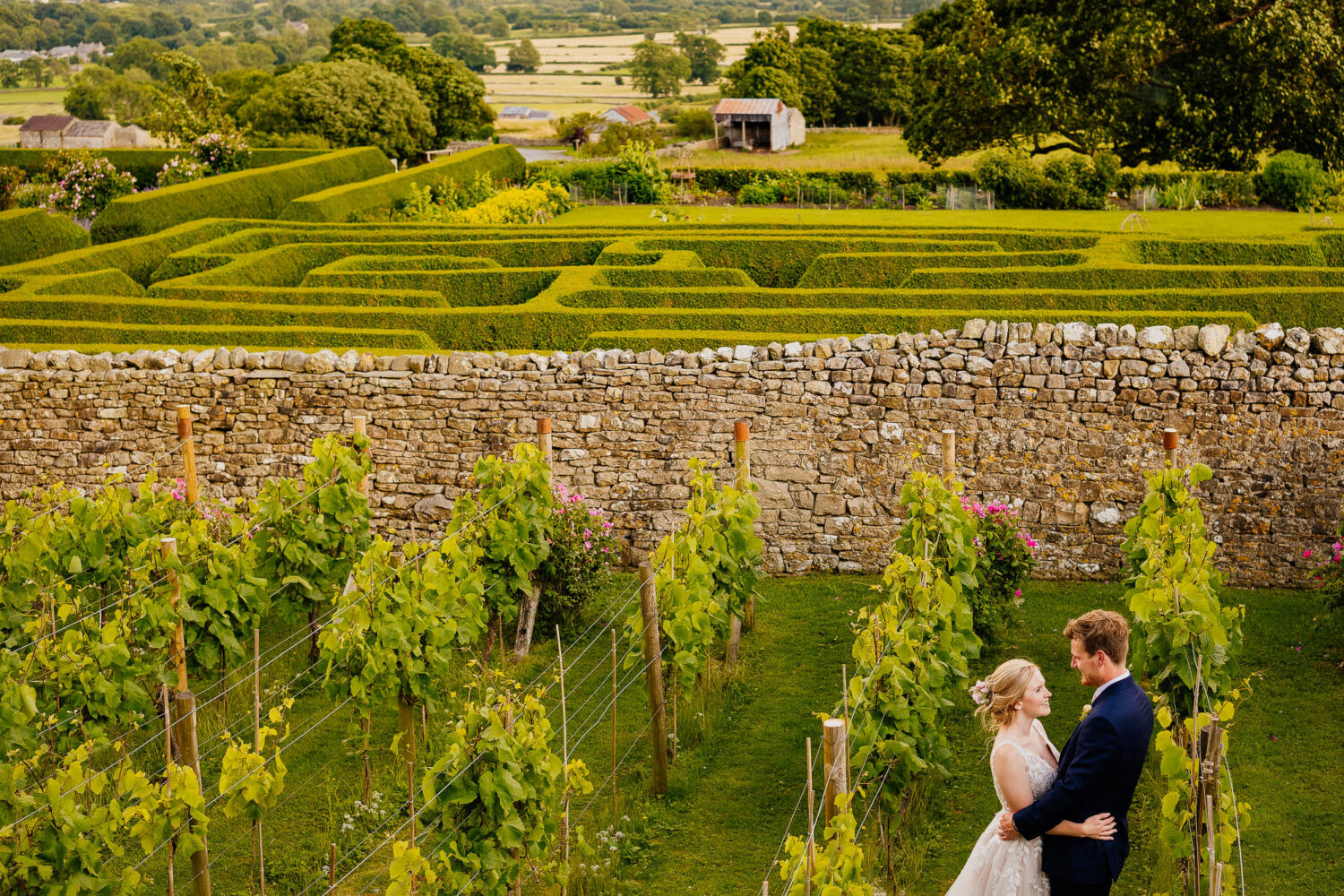 Couple hugging in the Vineyard at Bolton Castle