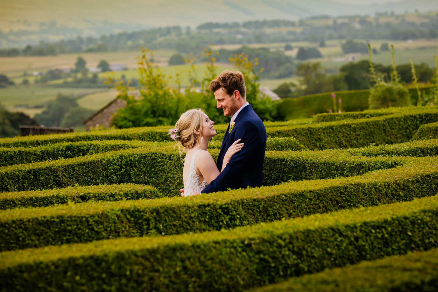 Couple hugging in the maze at Bolton Castle