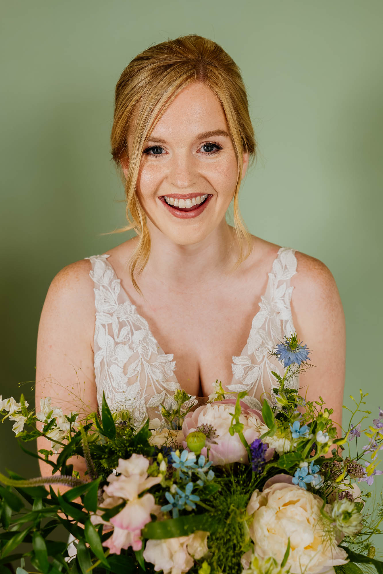 Bridal portrait with bride in wedding dress holding flowers