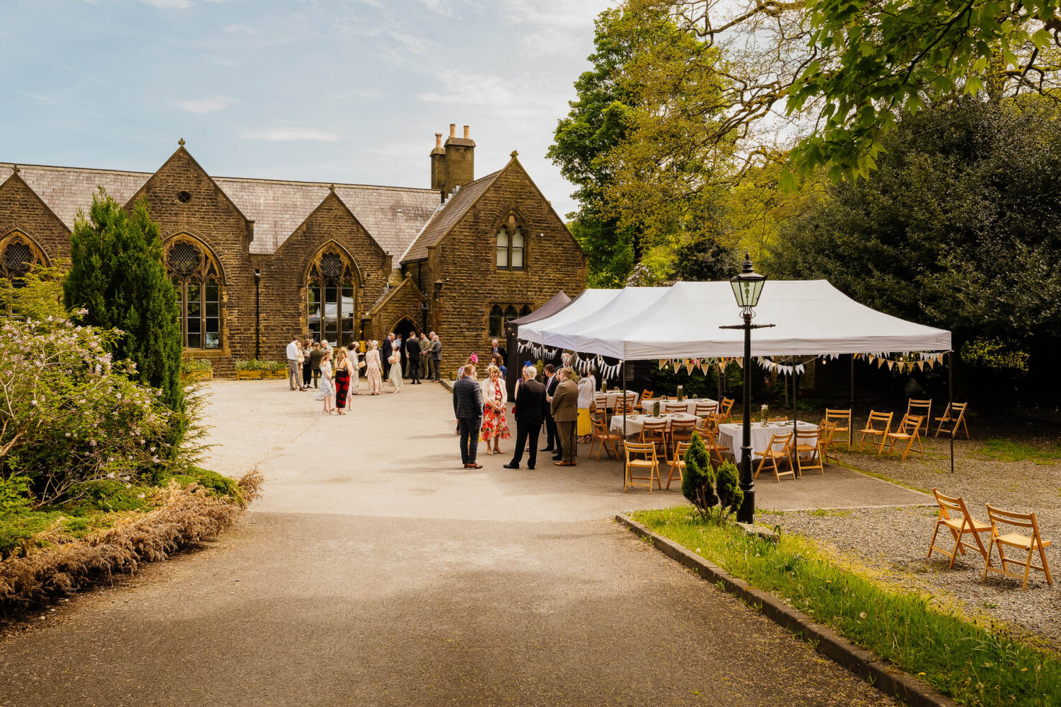 Guests waiting outside Fielden Hall wedding