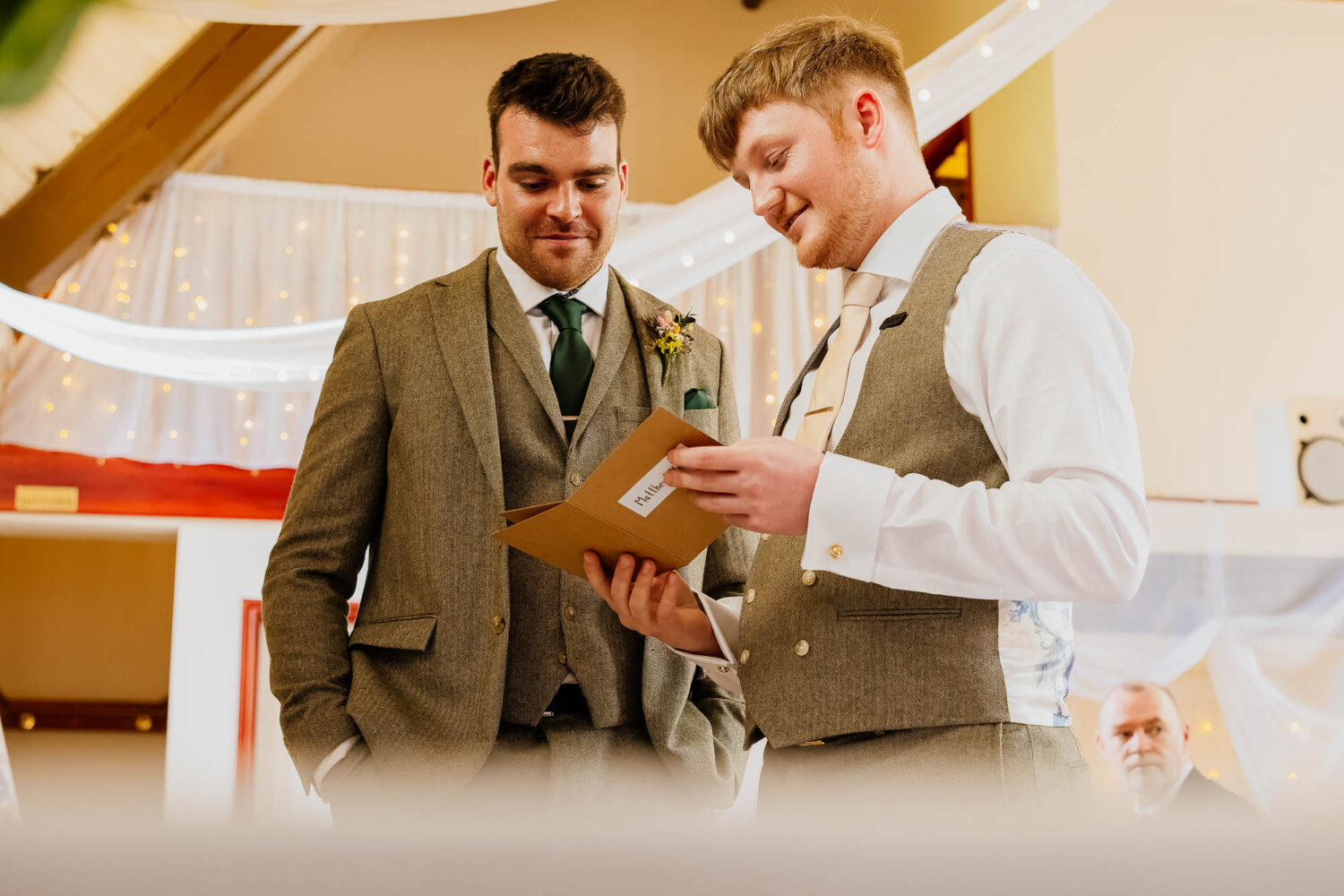 Groom reading vows with best man