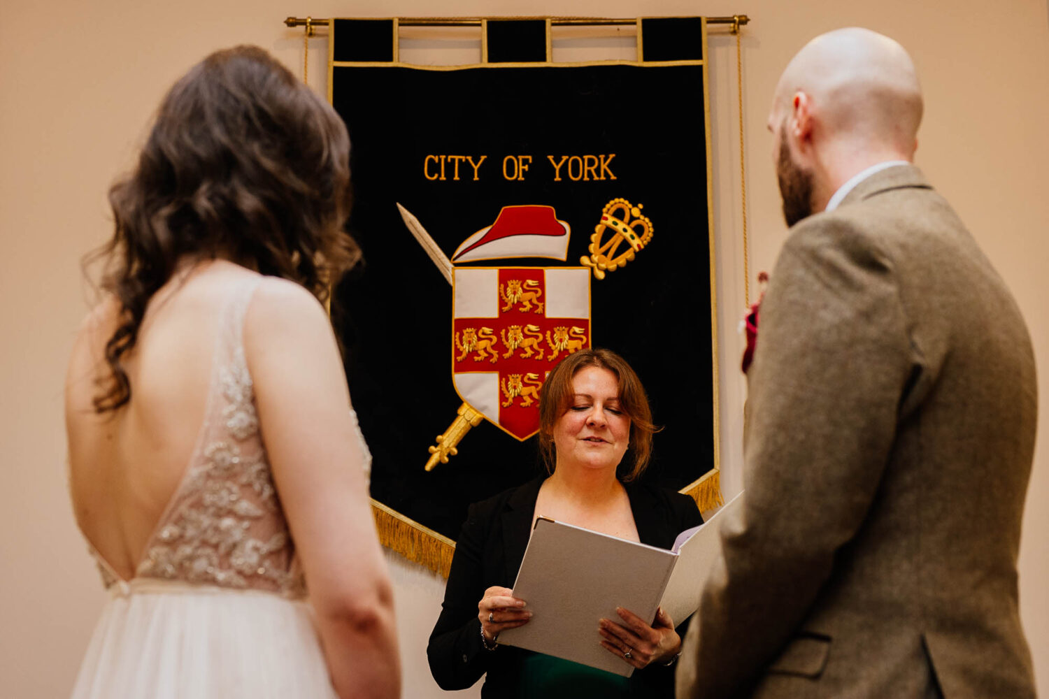 Bride and groom ceremony with City of York banner behind