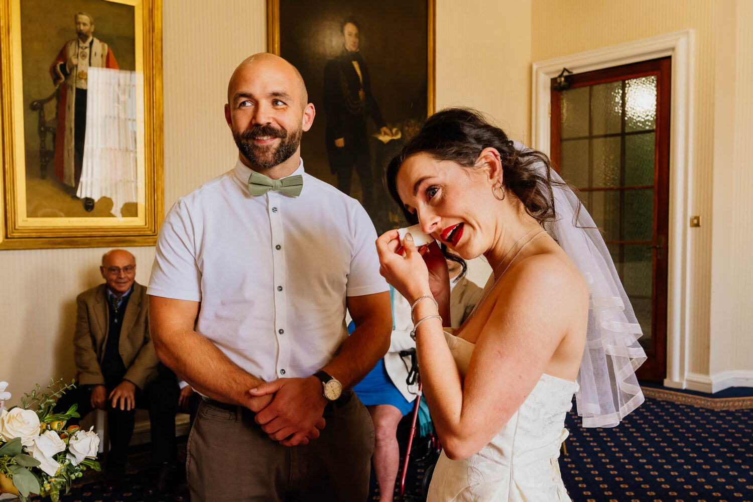 Bride wiping a tear during Leeds Civic Hall ceremony
