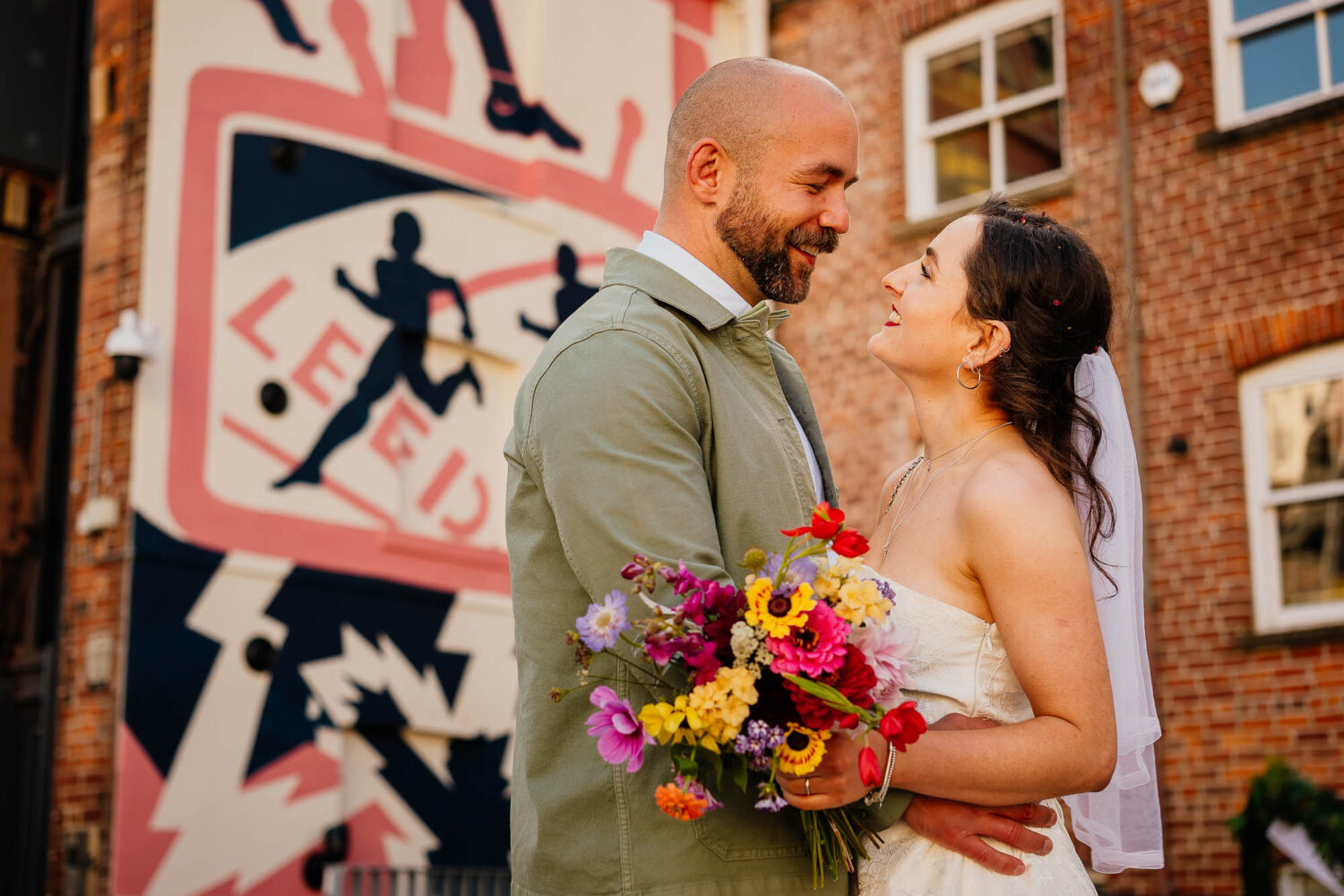 Couple portrait with Leeds graffitti in the background