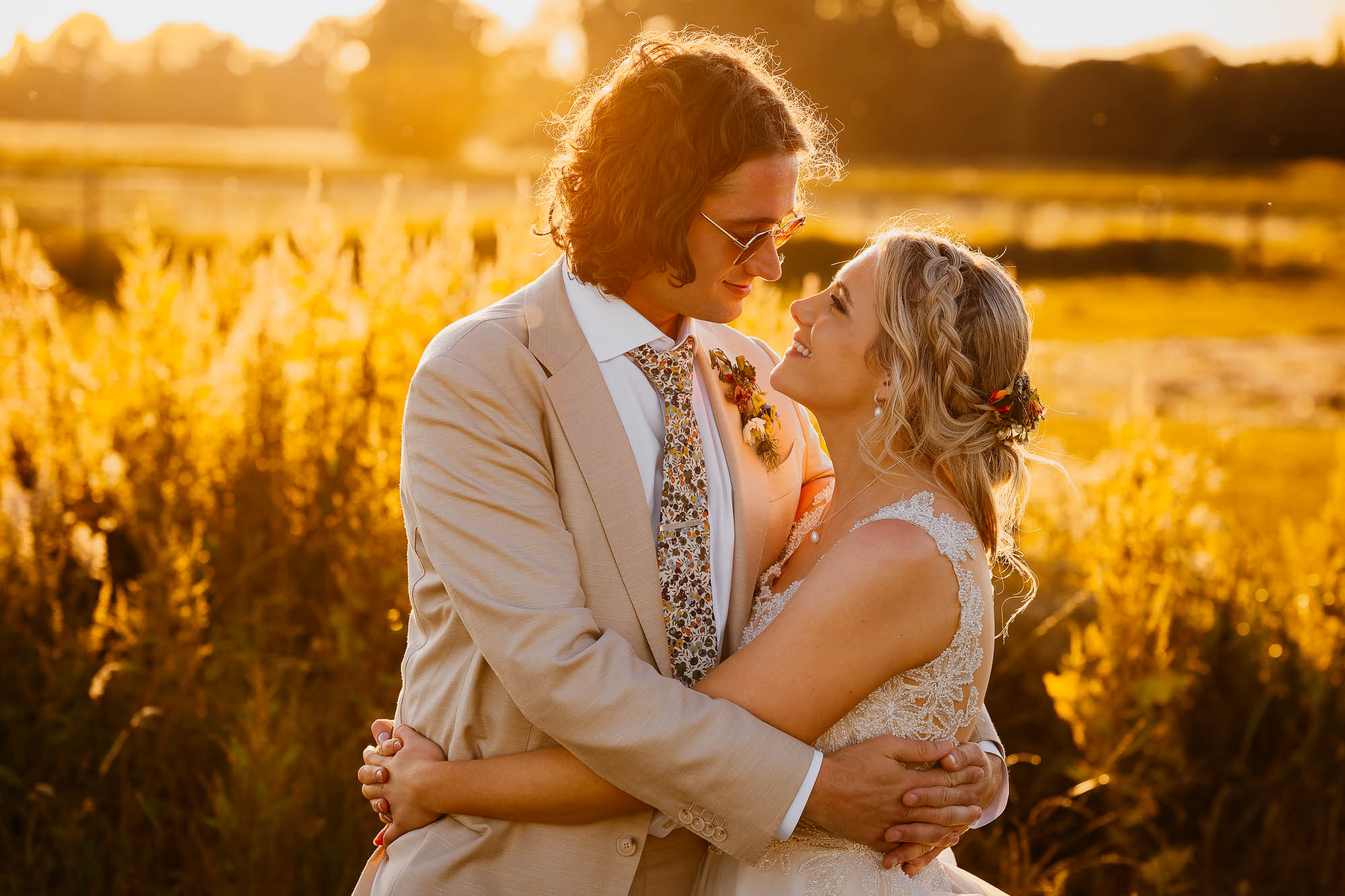 Bride and groom hugging at golden hour