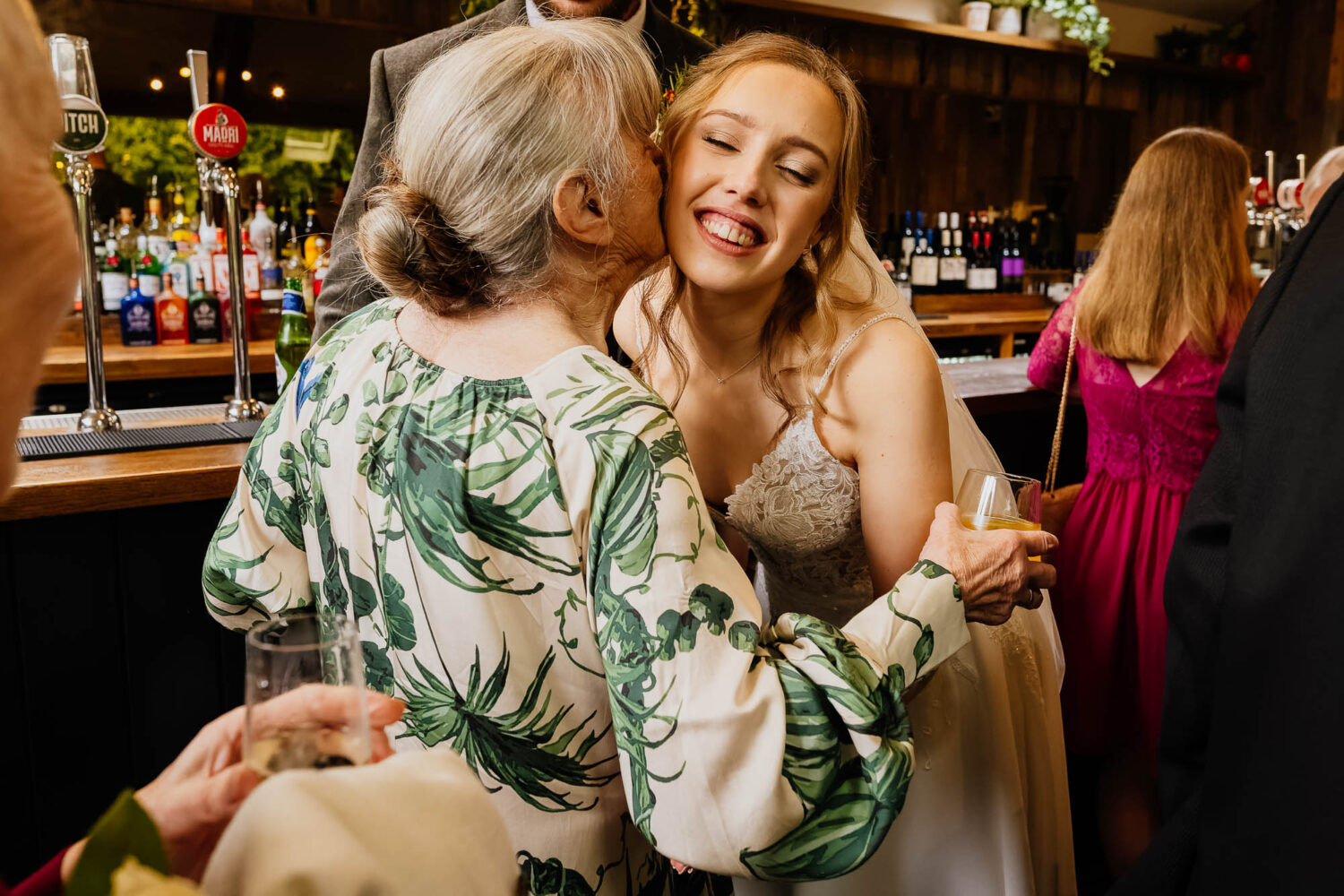 Bride being kissed on the cheek by grandma