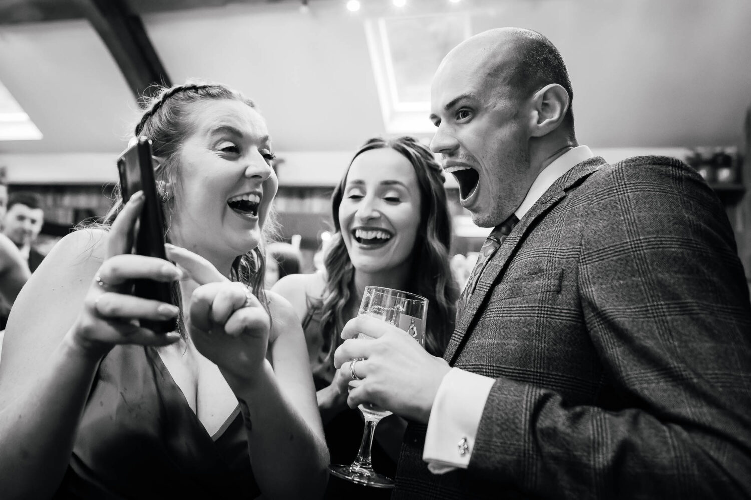 Wedding guests reacting to phone photo