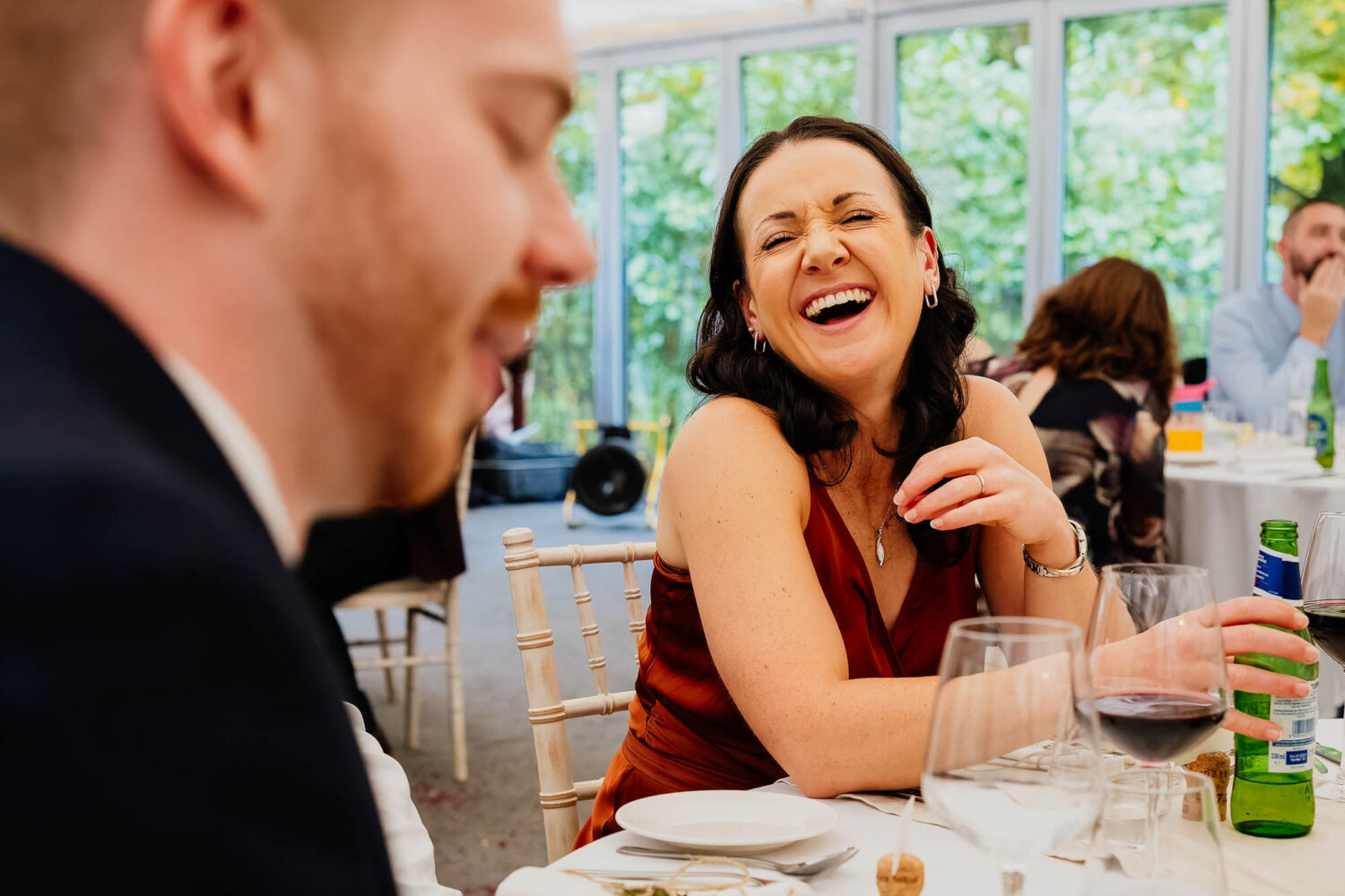Wedding guest laughing during wedding speeches