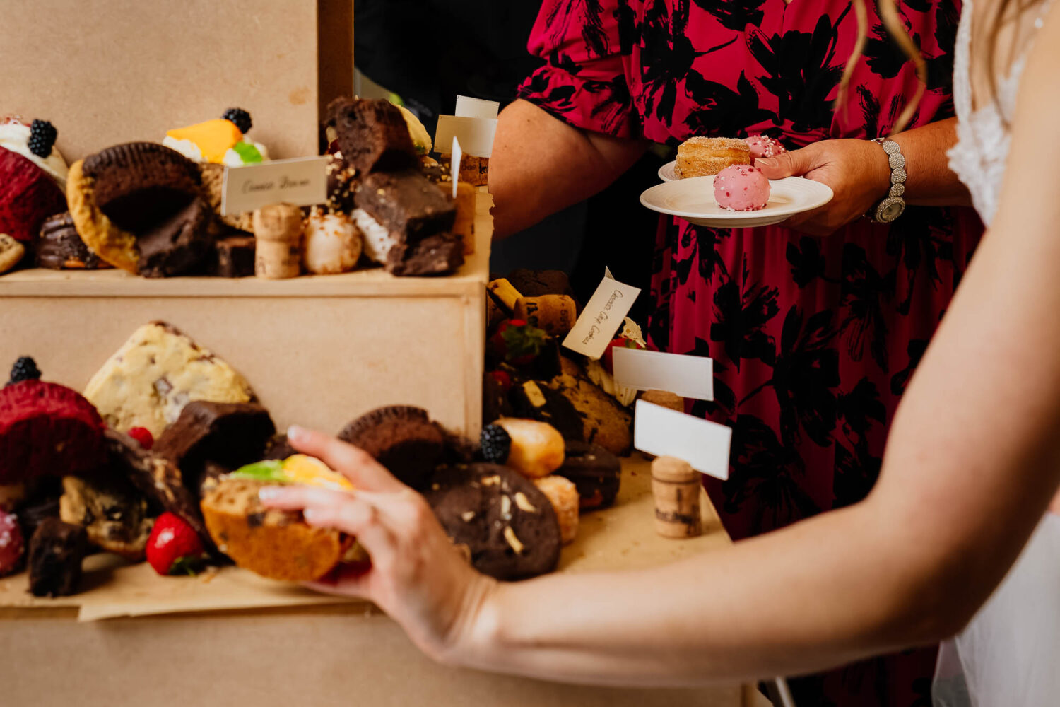 Bride and guests getting desserts from the desserts table