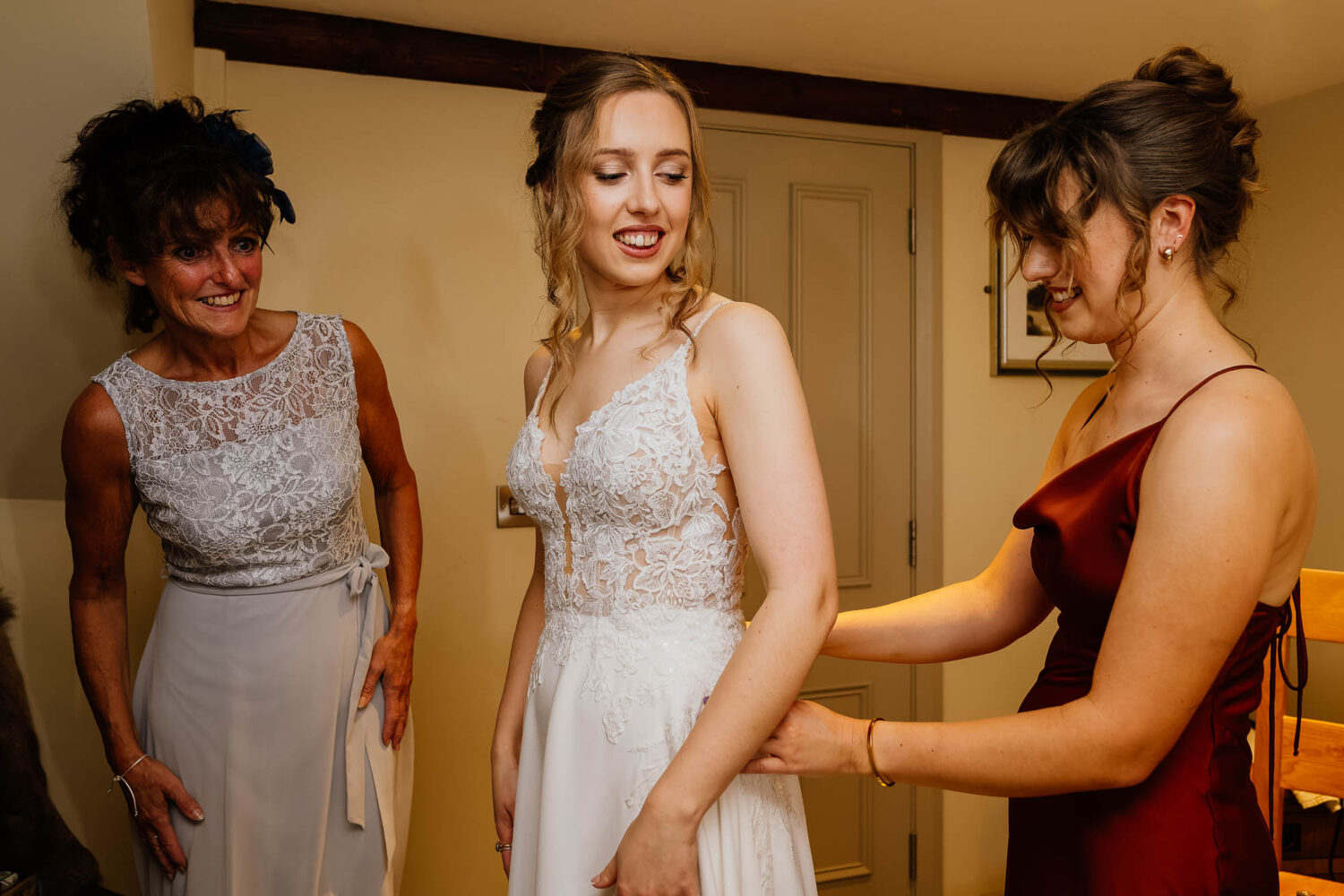 Bride getting dressed at the woodman inn