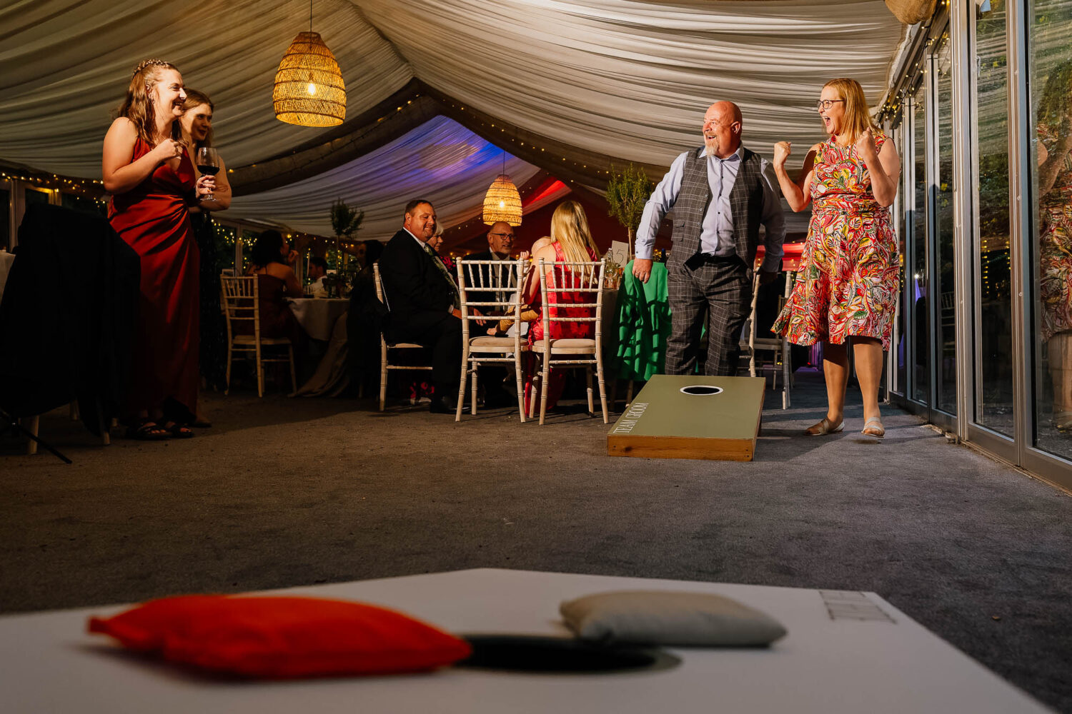 Guests reacting to corn hole win