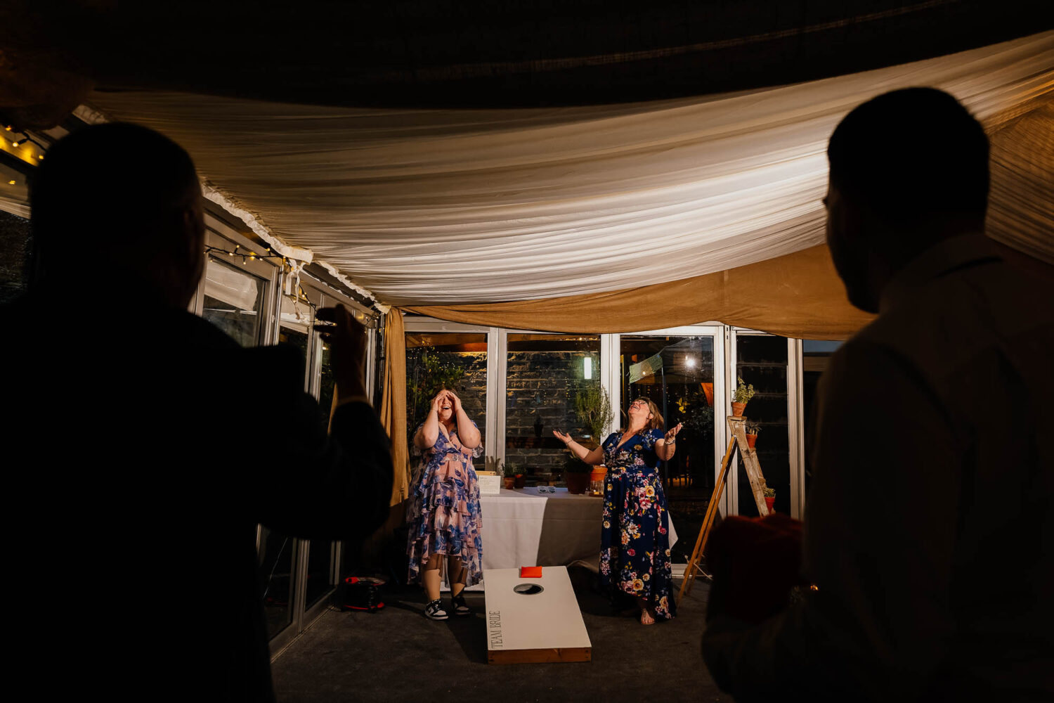 Guests paying corn hole in the evening