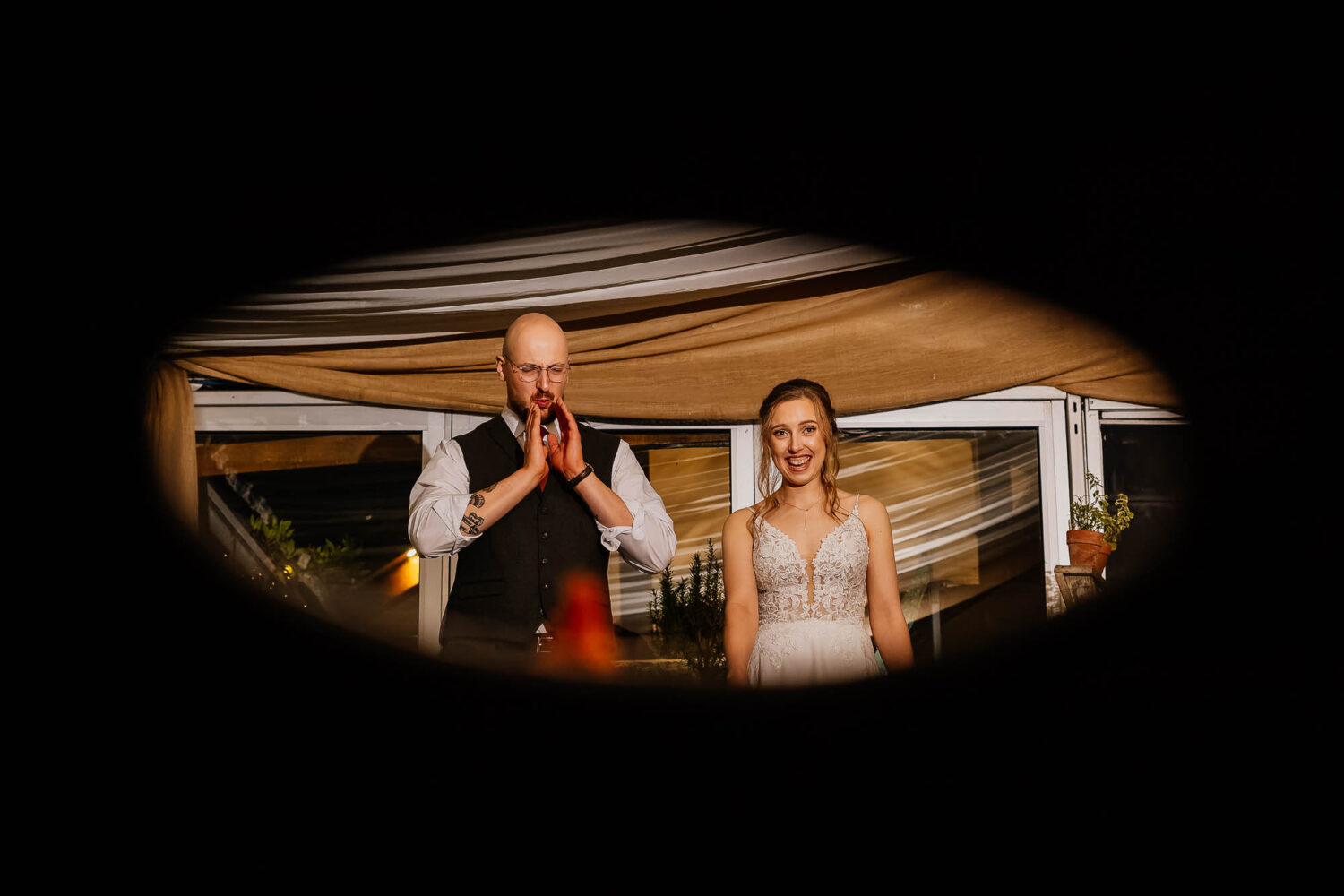 Bride and groom through cornhole whilst playing