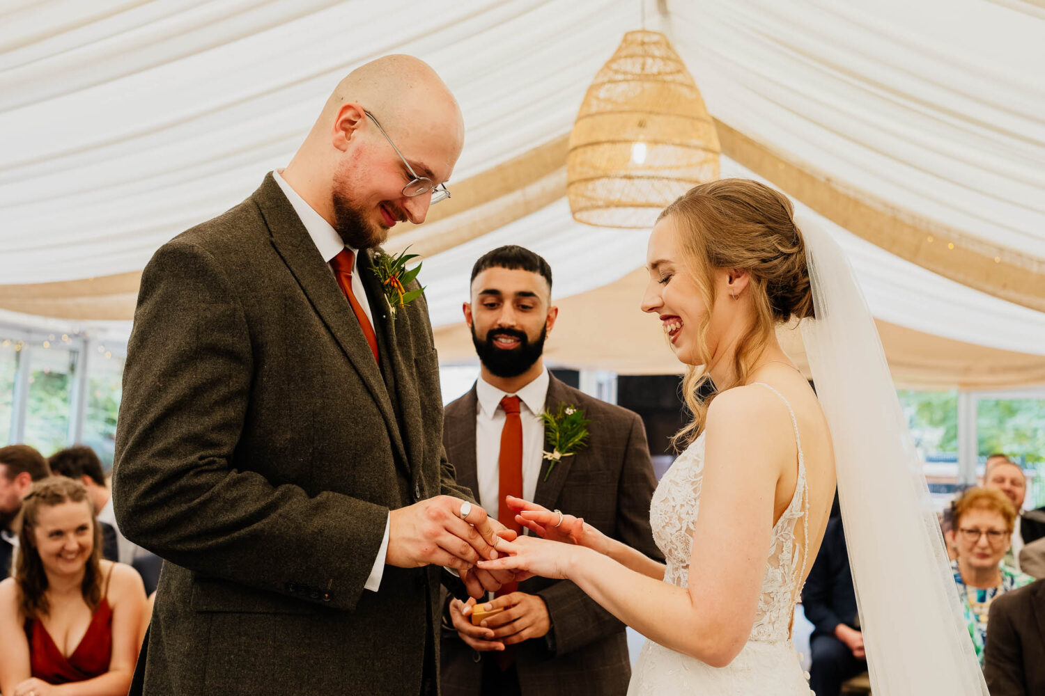 Ring exchange during garden room ceremony at The Woodman Inn